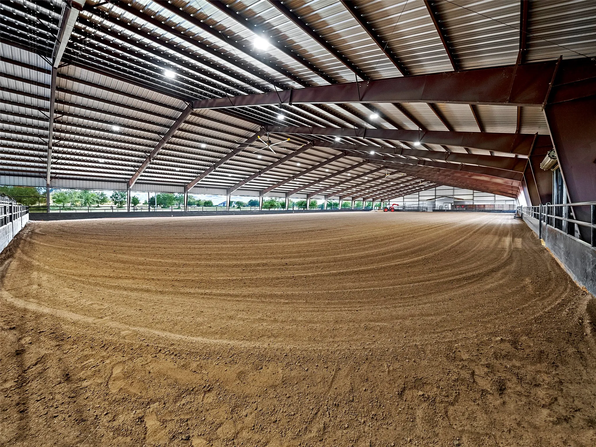 COVERED ARENA INTERIOR...Total Size (135x360), Riding Area Approx. (135x280), Under Roof Includes A 60 Ft Round Pen, 6-Horse Eurociser, 10 Tie Stalls & 5 Pipe/Welded Wire Stalls