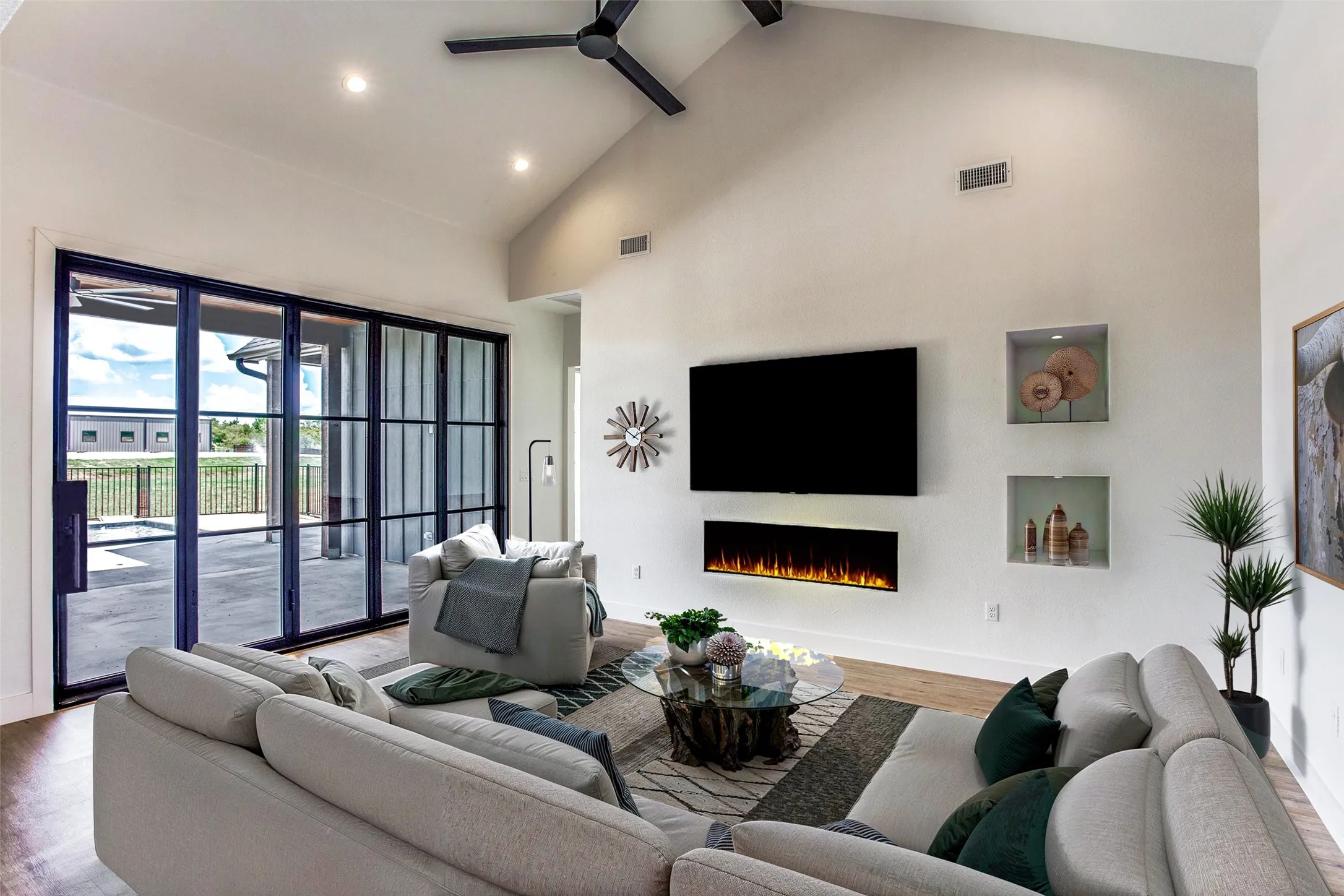 LIVING ROOM...Luxury Vinyl Floor, Vaulted Ceiling, Open To The Foyer, Kitchen And Dinette, Fireplace, Accordian Type Patio Doors That Open Completely To The Covered Back Patio