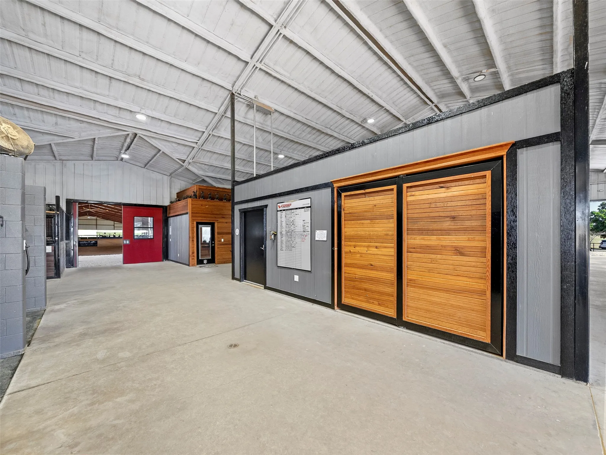 MAIN BARN INTERIOR...Exterior View Of Huge Tack Room W/Rotating Saddle Wall