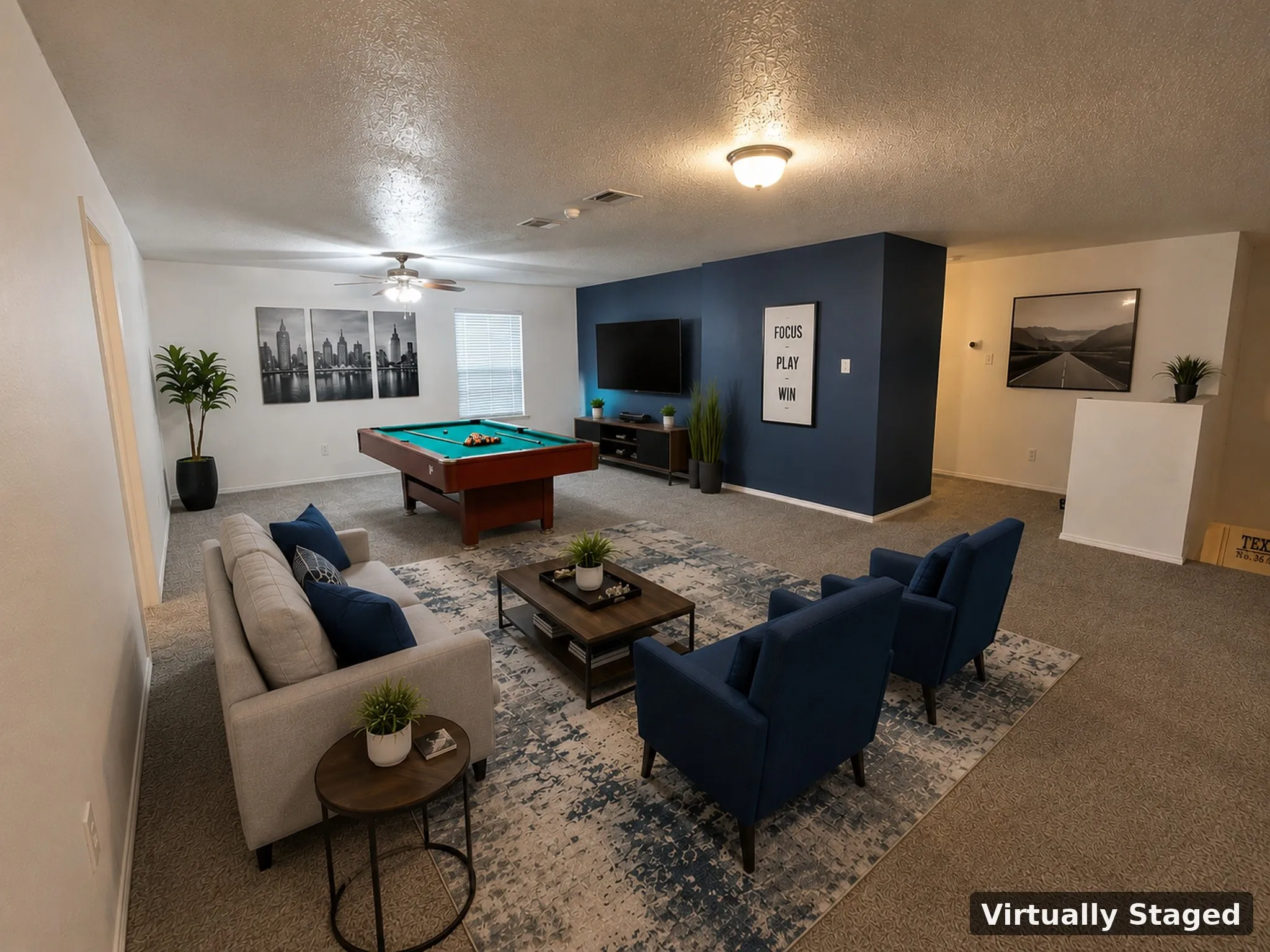 Spacious room featuring ceiling fan, recessed lighting, and a prominent accent wall