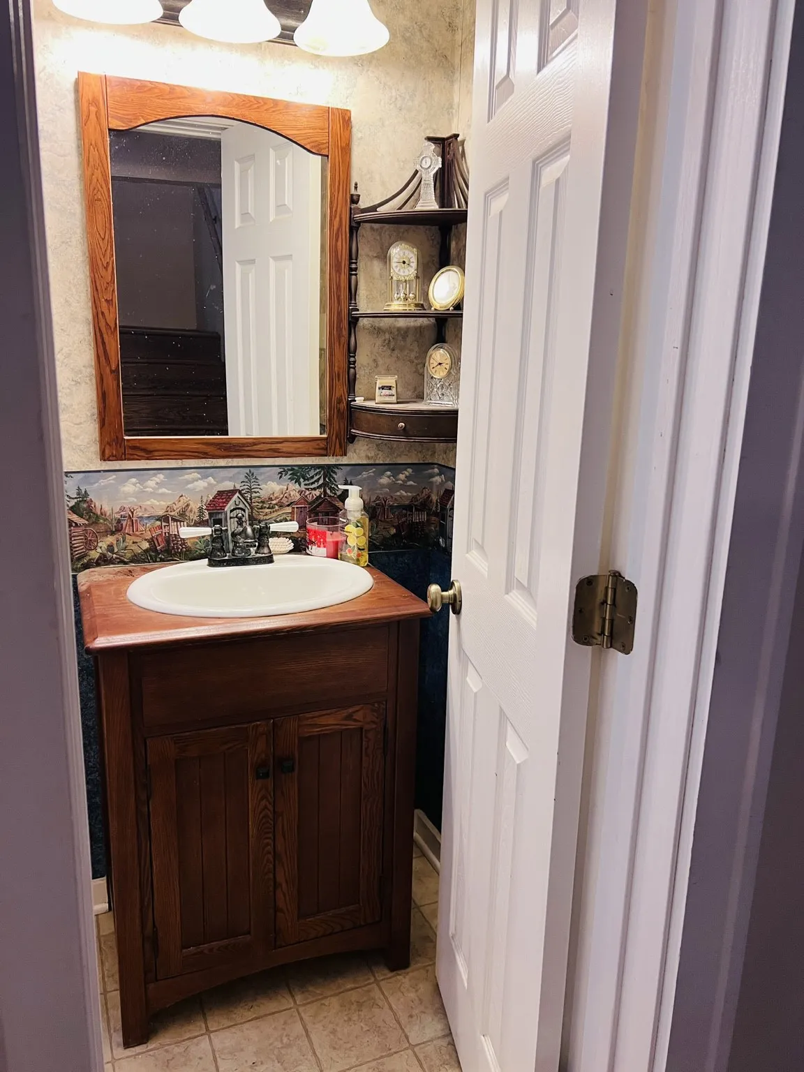 Hall full bathroom  featuring a wood-finish cabinet, integrated sink, and wall-mounted mirror