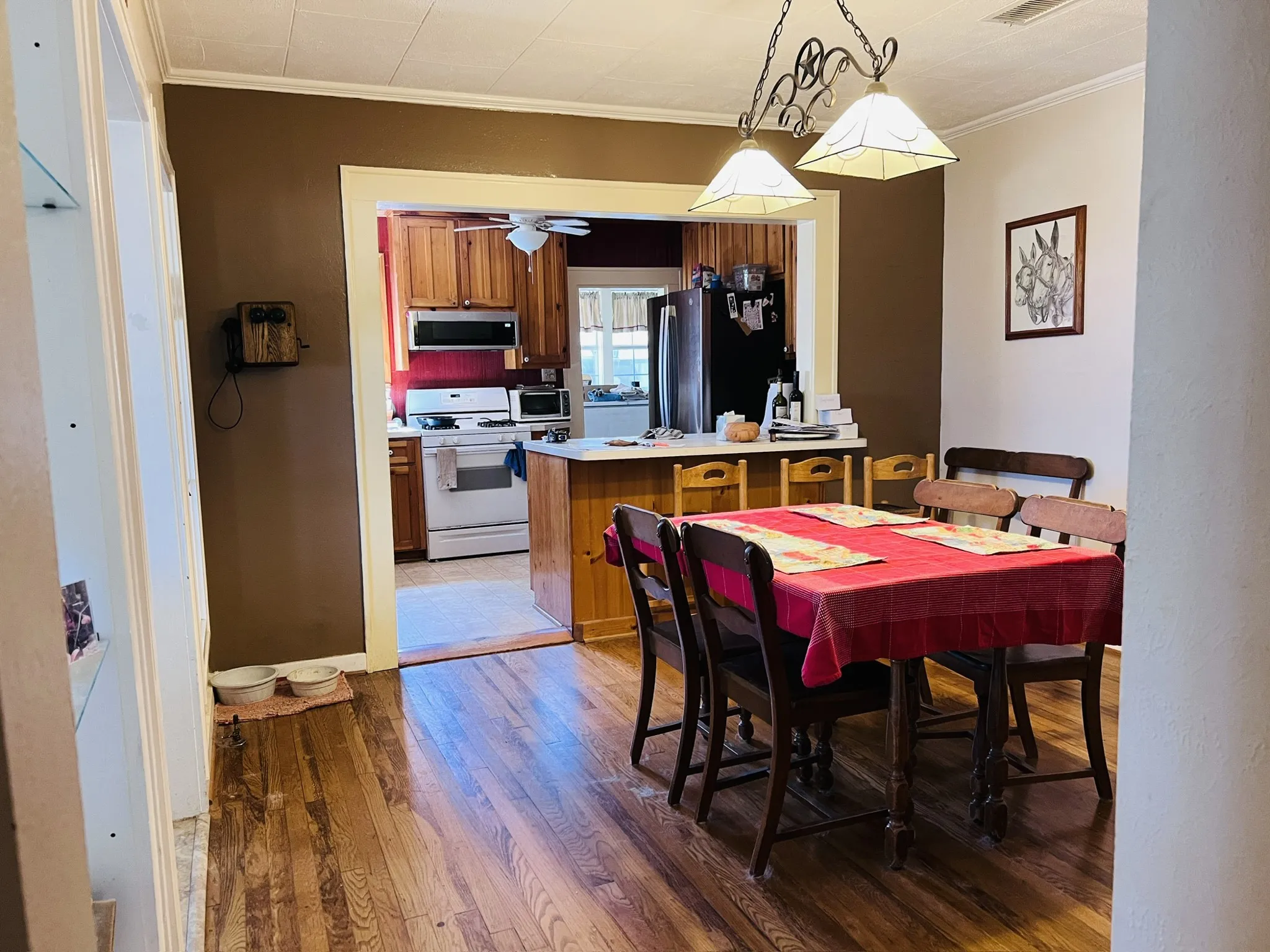 Dining area featuring wood-finish flooring and a decorative chandelier