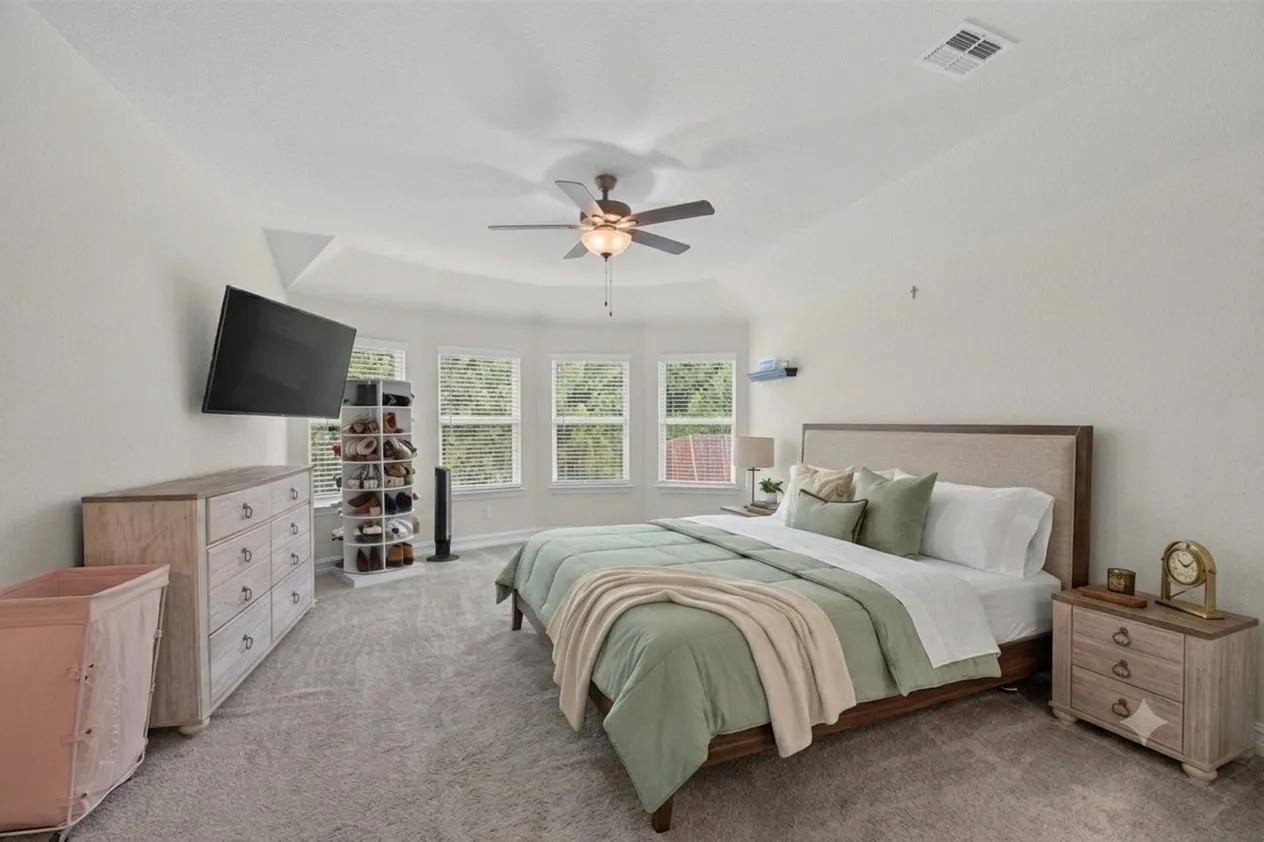 Carpeted room featuring a ceiling fan with light fixture, multiple windows with blinds, and recessed lighting