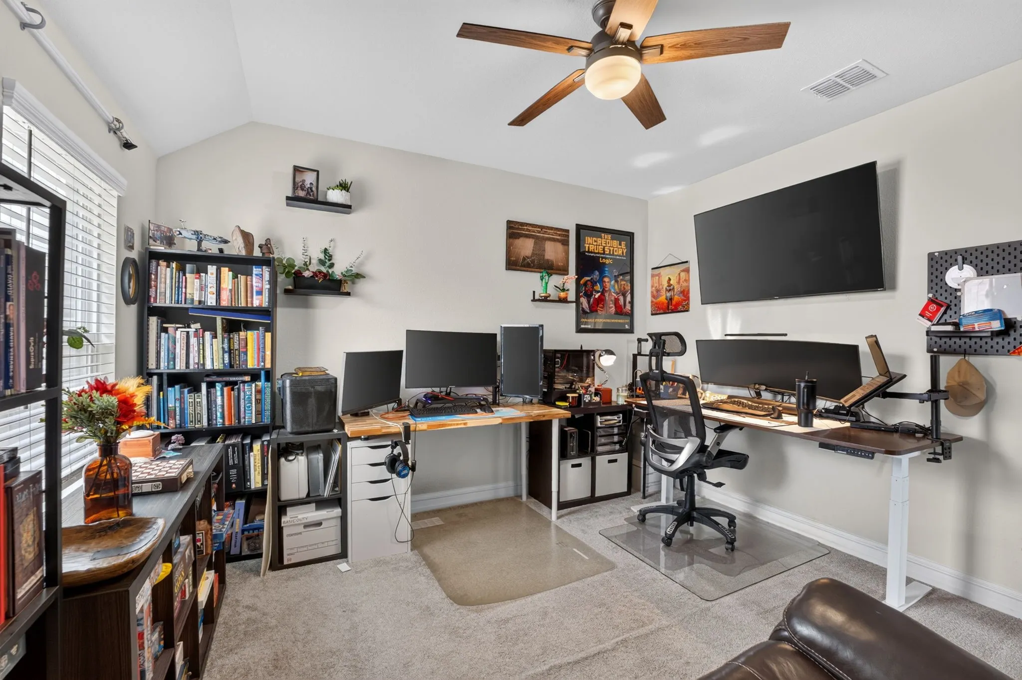 Versatile room featuring a vaulted ceiling and a ceiling fan with integrated lighting
