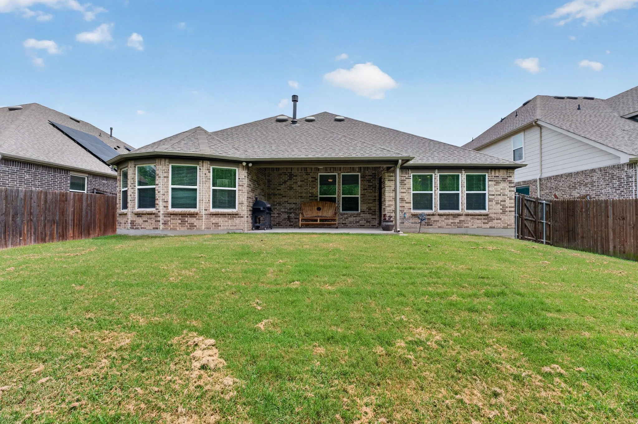 Expansive backyard with a green lawn