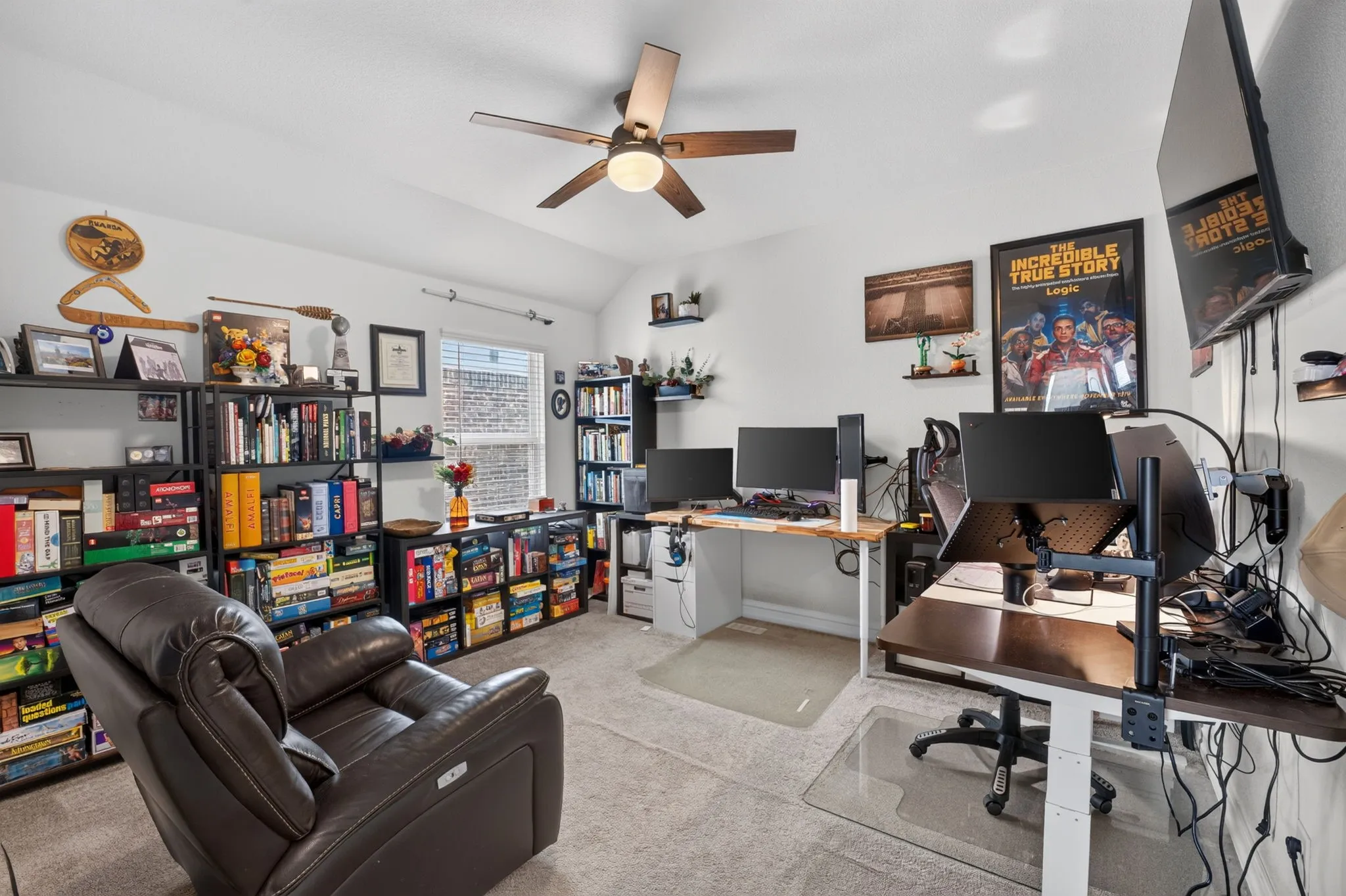 Versatile interior room featuring a ceiling fan, recessed lighting, and a large window providing natural light