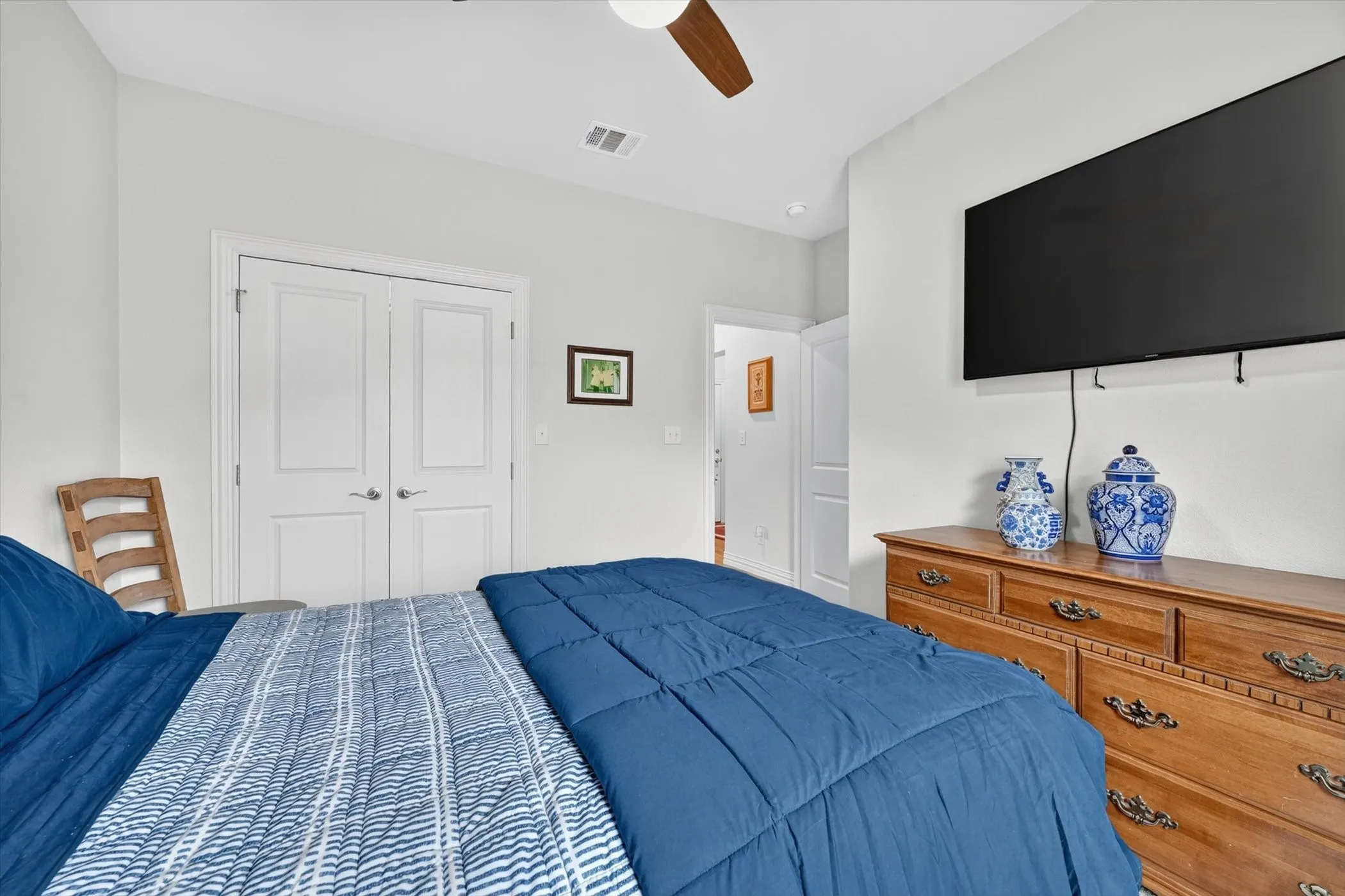 Interior room featuring a ceiling fan, light gray wall paint, and white trim