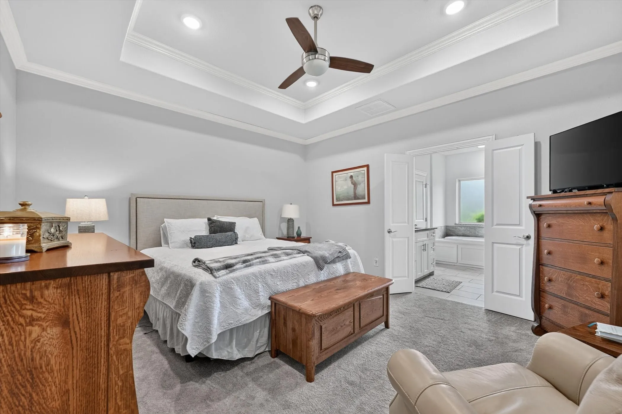 Tray ceiling with recessed lighting and a ceiling fan