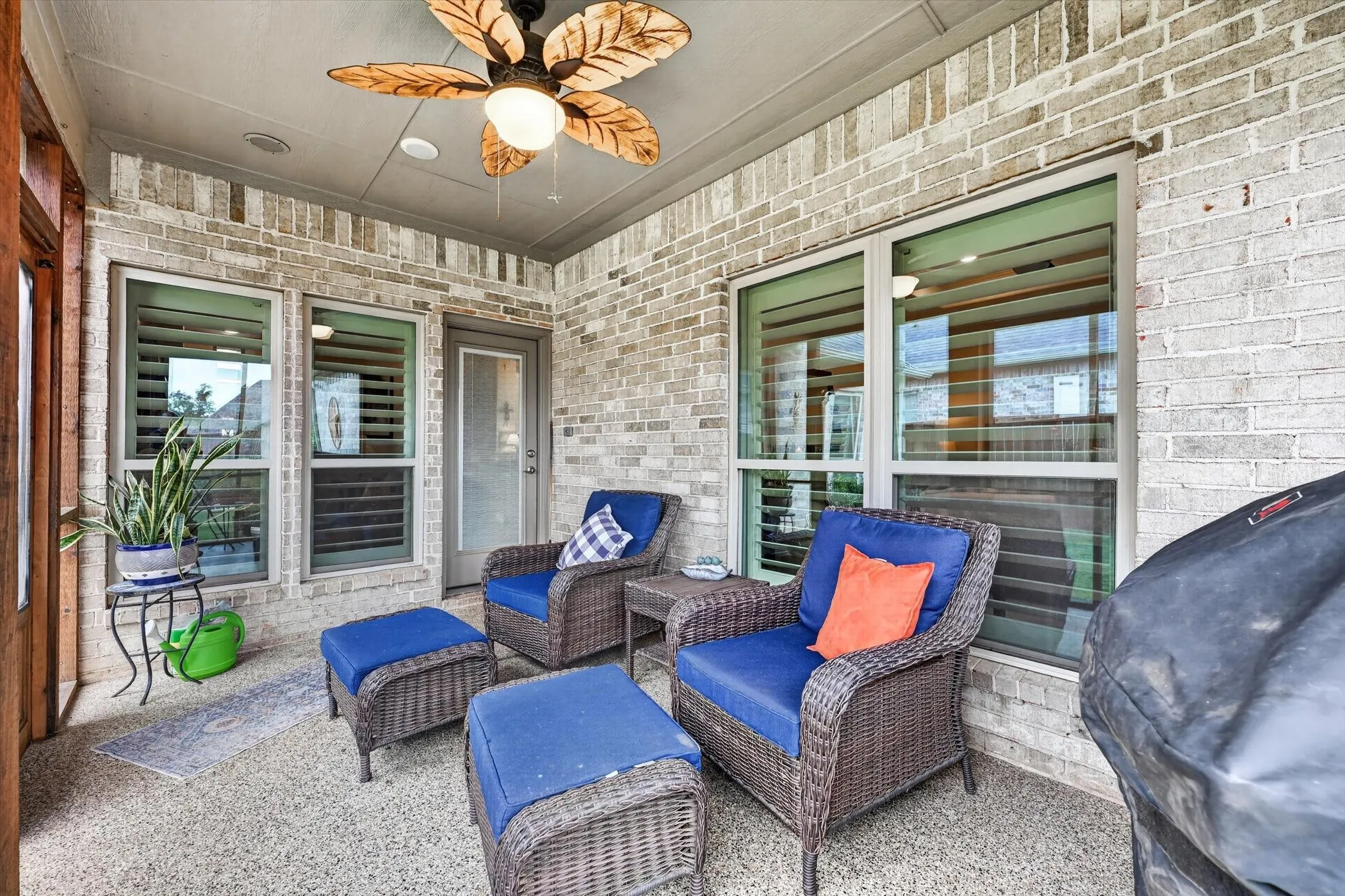 Covered patio featuring a ceiling fan with leaf-shaped blades, recessed lighting, and a textured concrete floor