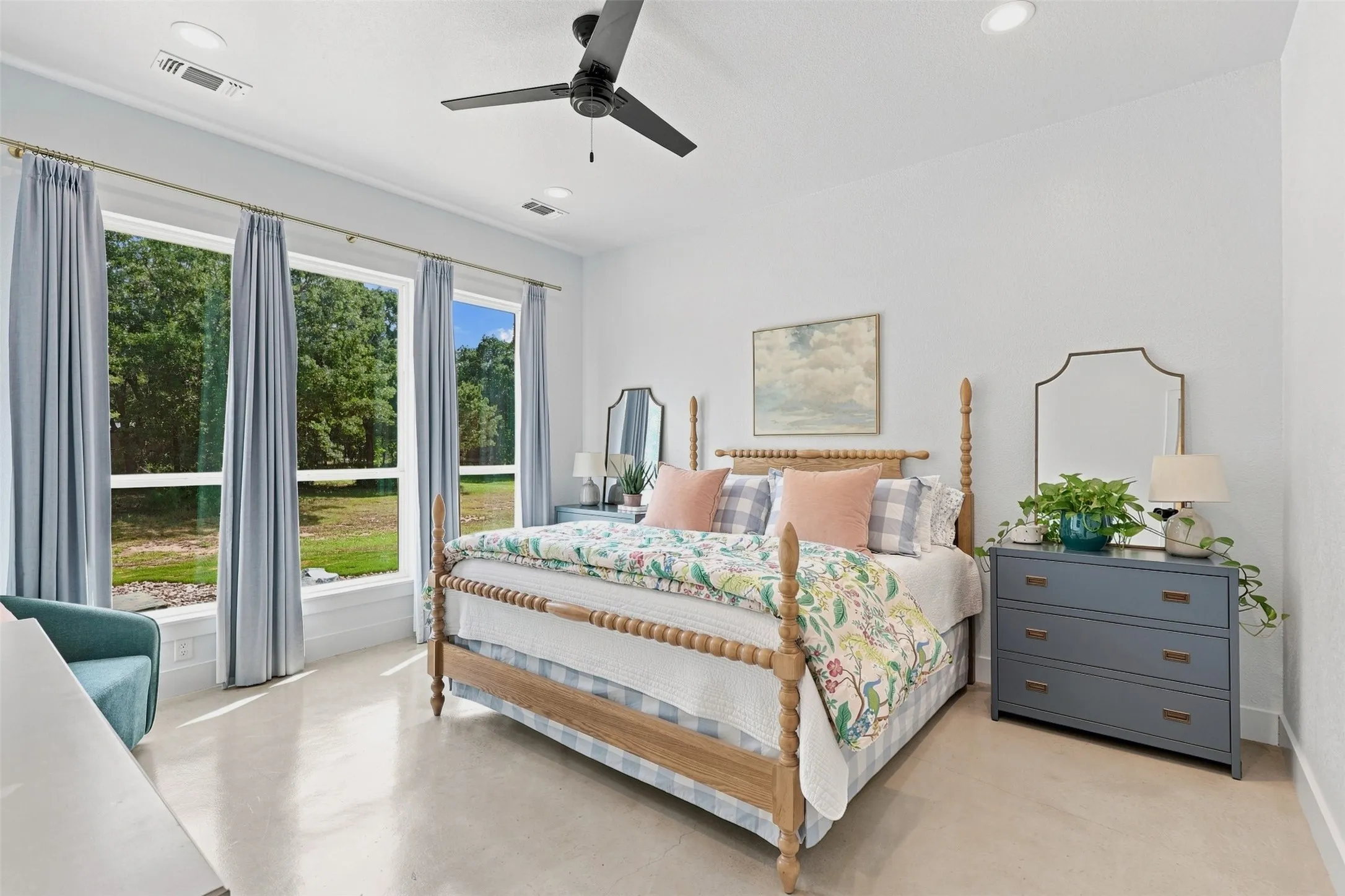 Primary Bedroom downstairs offers natural light and beautiful views.