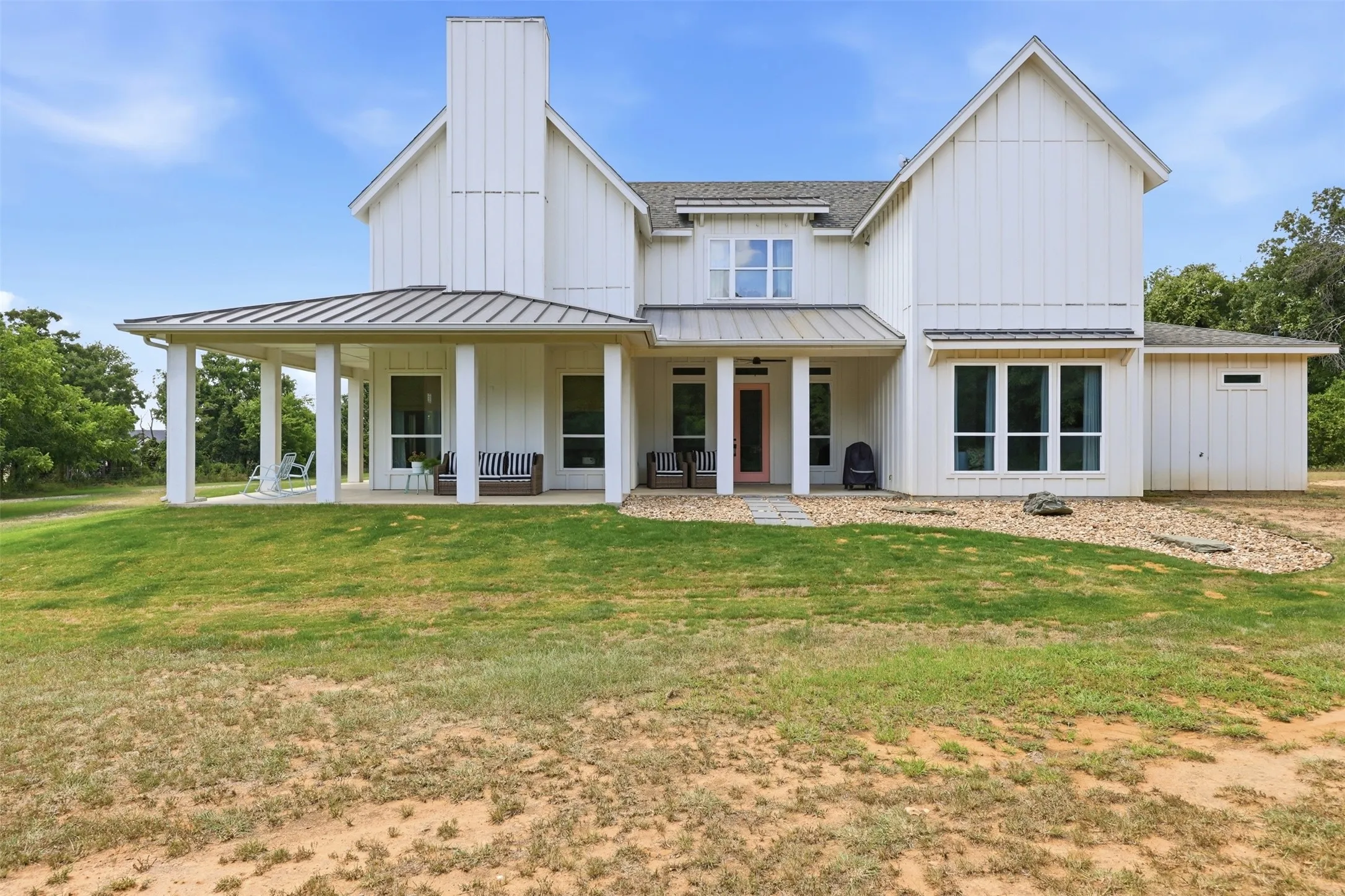Wonderful covered porch extends around the side of the house. Private view of the back of the property from this area.