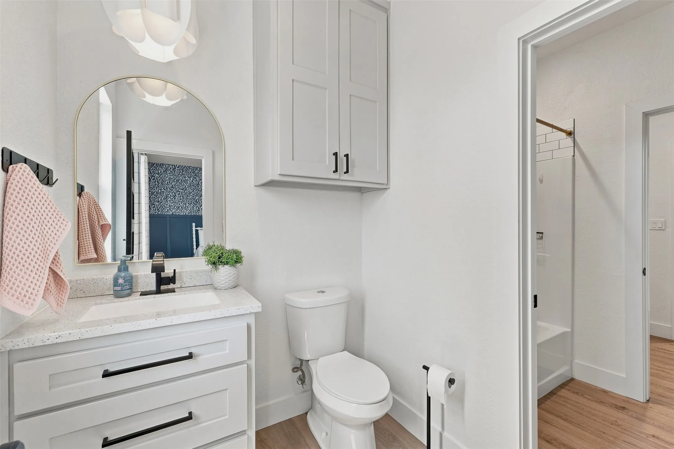 Upstairs Hollywood-style bathroom offers dual private vanity/toilet areas connected by the shared tub/shower in between.