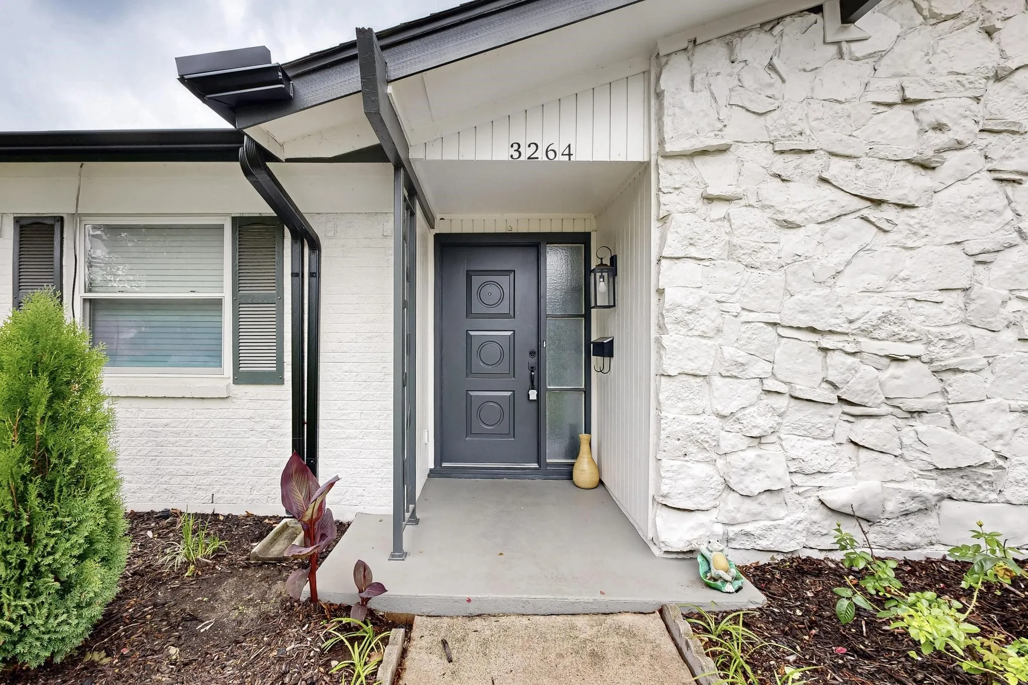 Doorway to property with stone siding