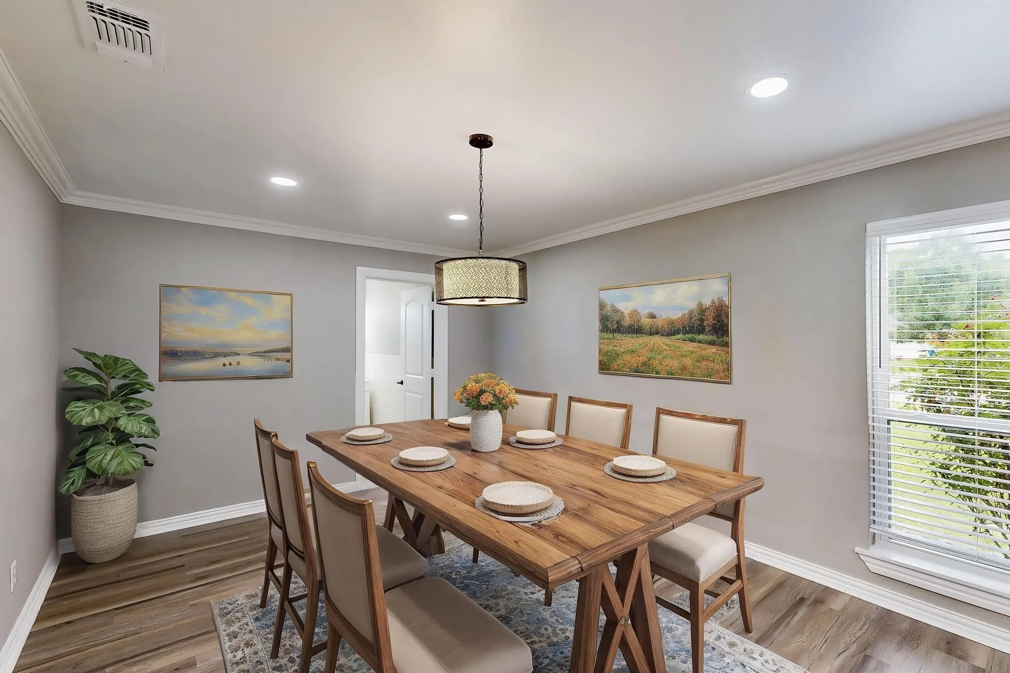 *Virtually staged*
Dining room with wood finished floors, baseboards, ornamental molding, and recessed lighting
