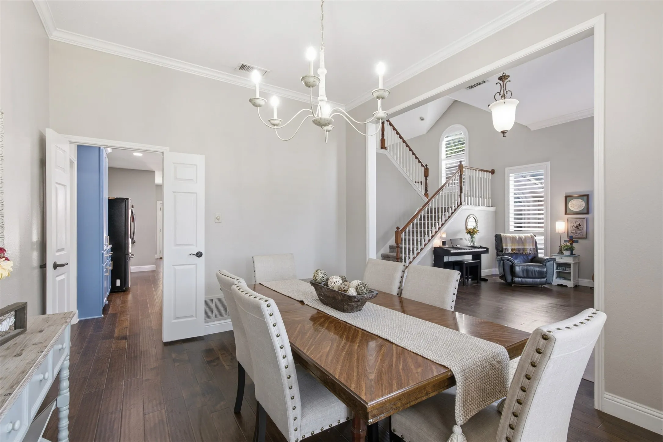 Formal dining area featuring hardwood-finish flooring and a white chandelier