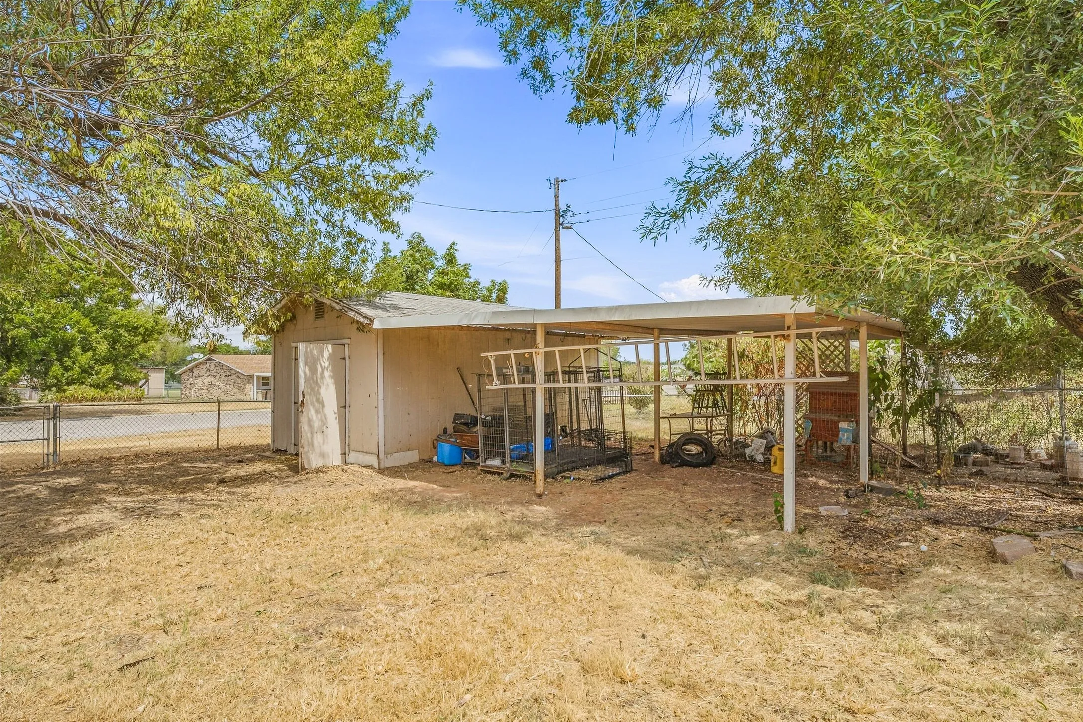 Detached storage shed with an attached covered carport