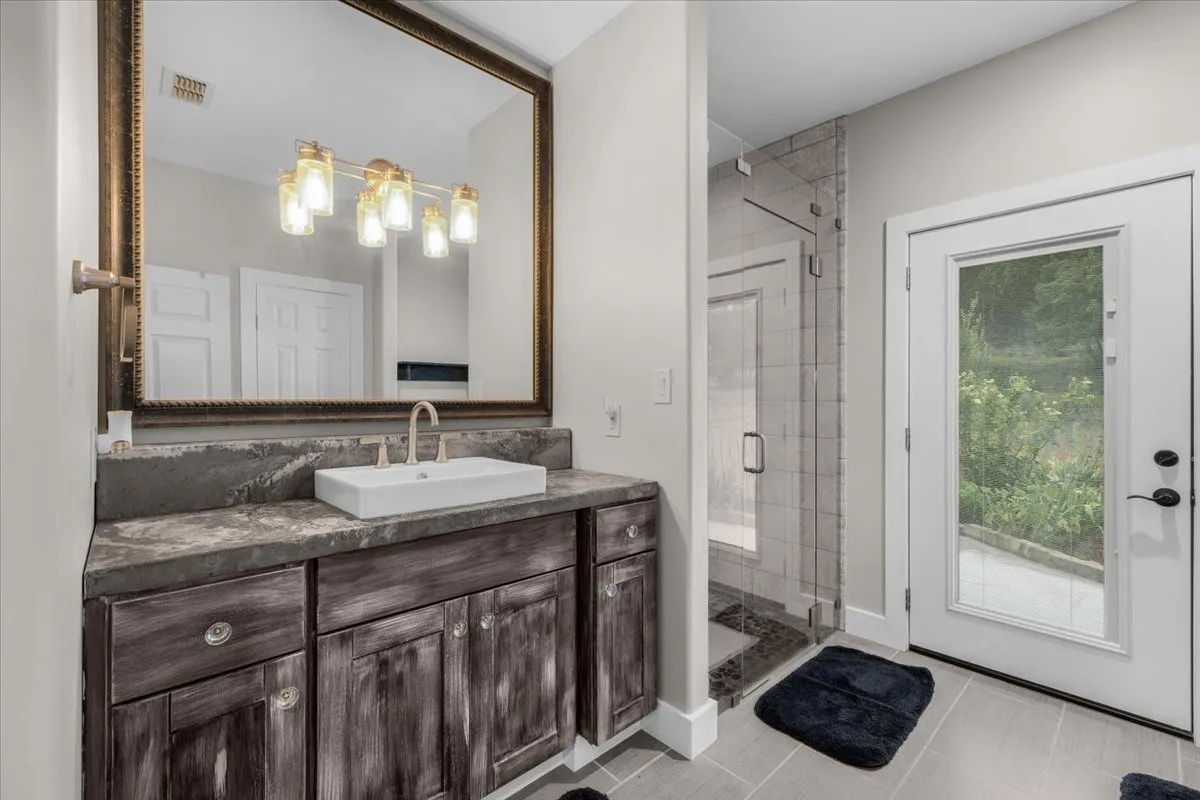 Distressed wood-finish vanity with a rectangular vessel sink and gold-finish faucet