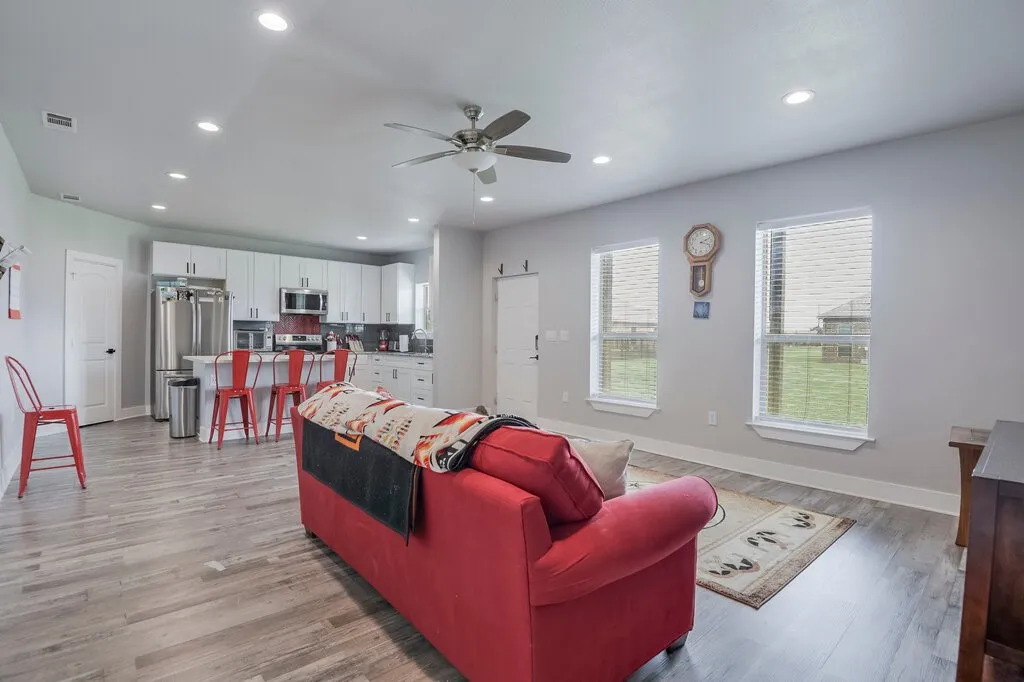Open-concept living area featuring wood-finish flooring and recessed lighting
