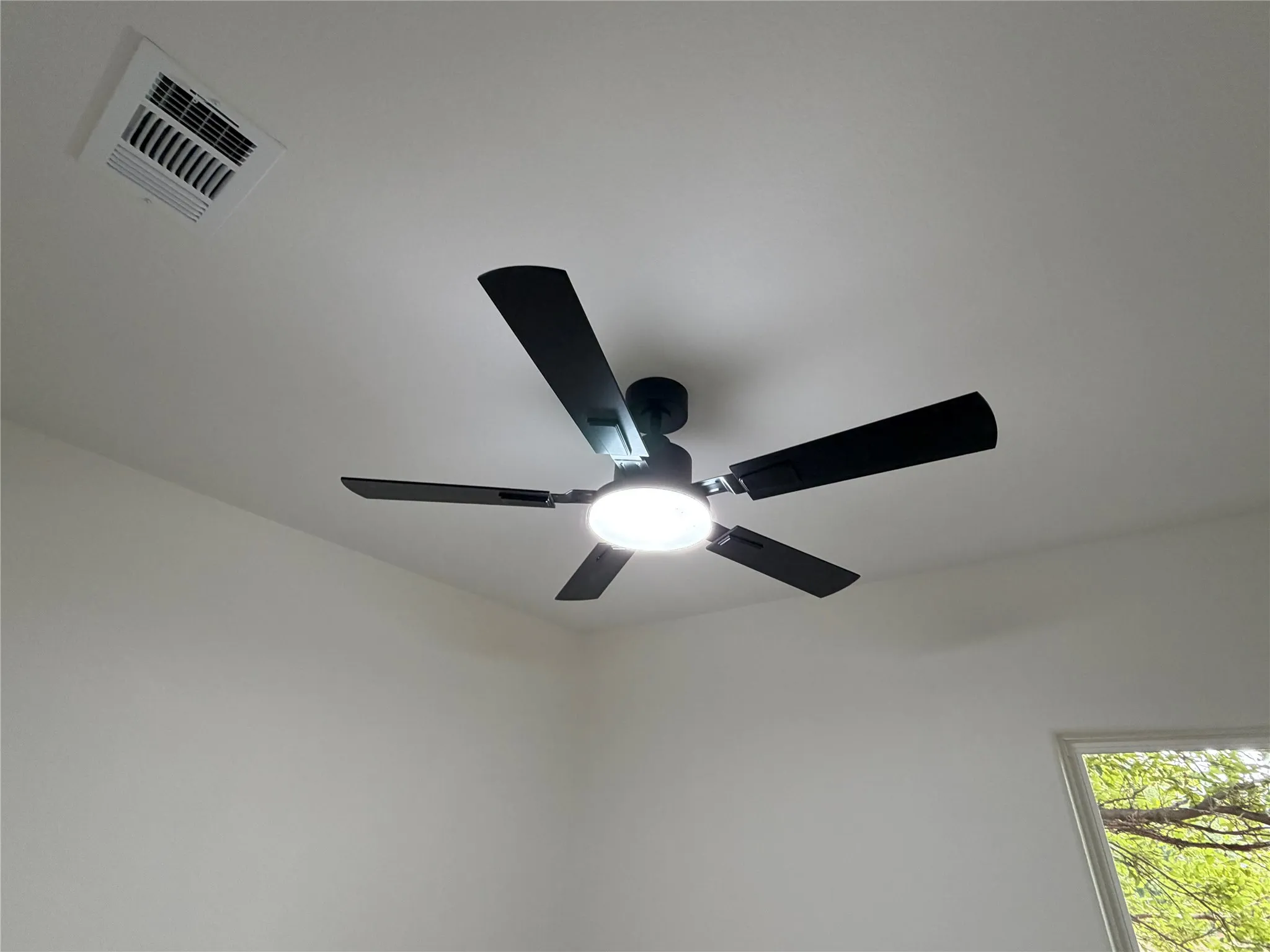 Modern ceiling fan with five black blades and integrated LED lighting