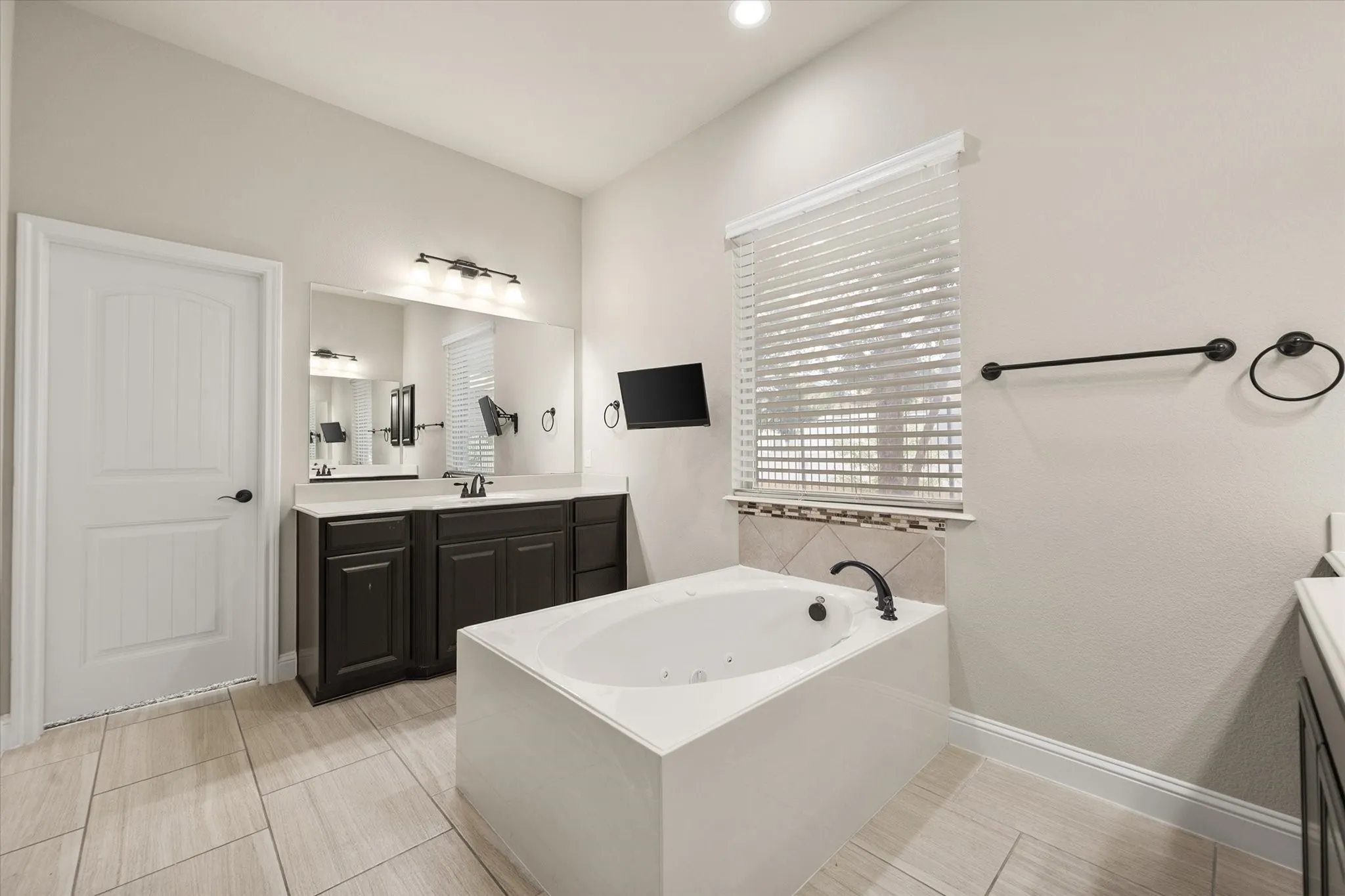 Primary bath with separate vanities ensures an abundance of space for all.