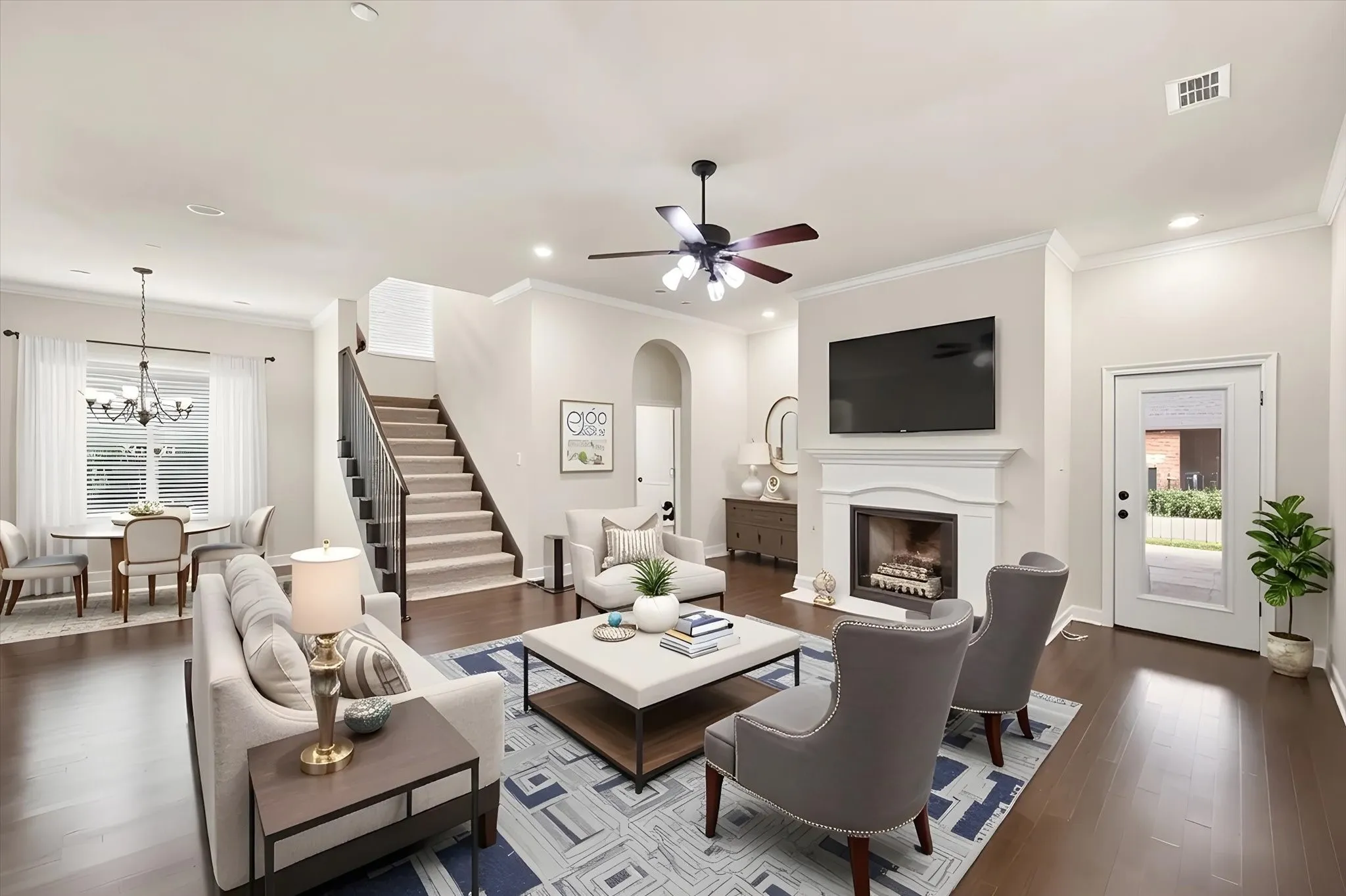 Elegant fireplace is a focal point in this open floorplan. Virtually staged to show use.