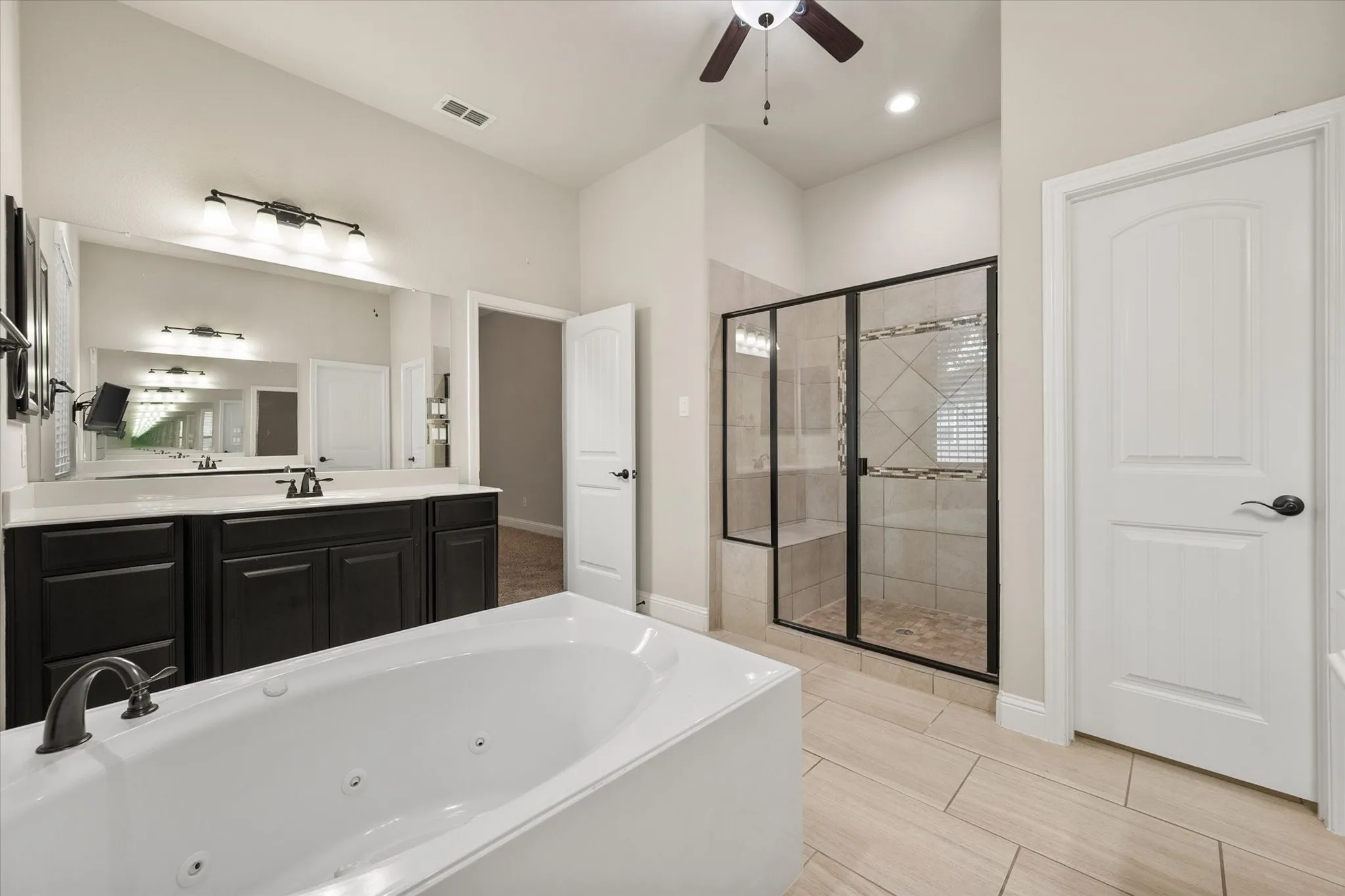 Large jetted tub is perfect for relaxing after a long day.
