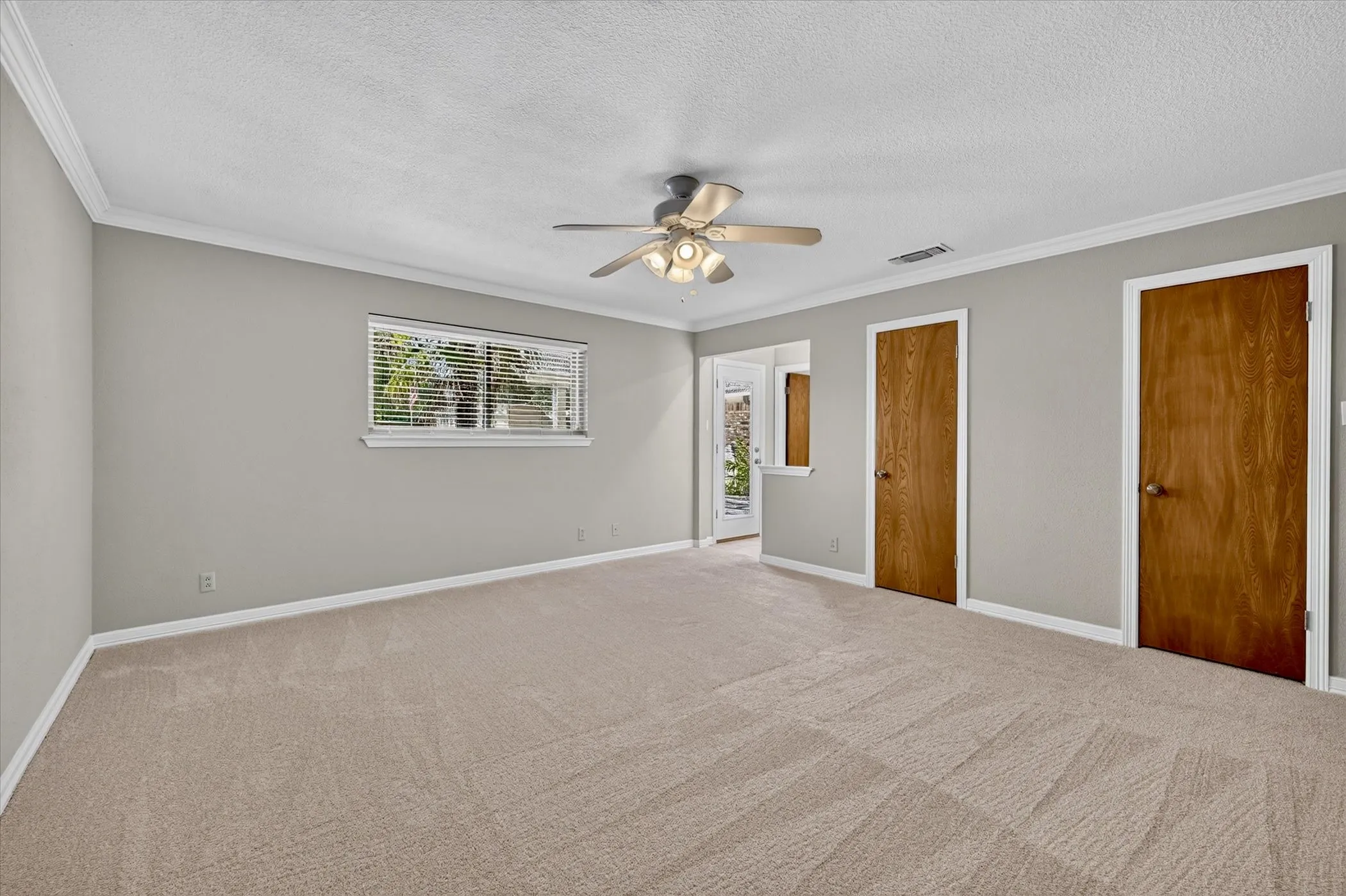 Oversized primary bedroom offers plenty of space for a sitting area or reading nook