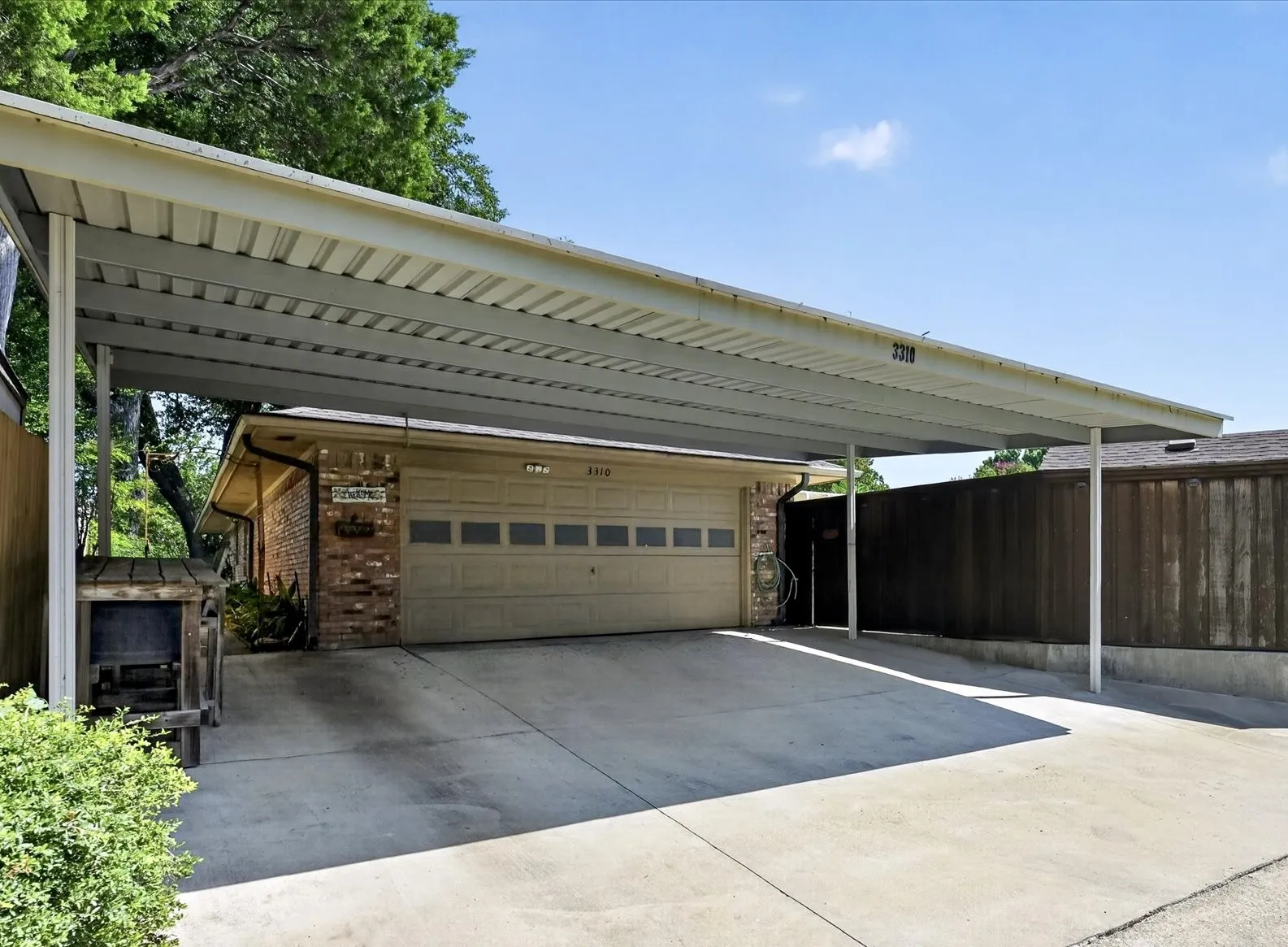 Oversized two-car garage with an attached three-car carport provides exceptional covered parking and storage