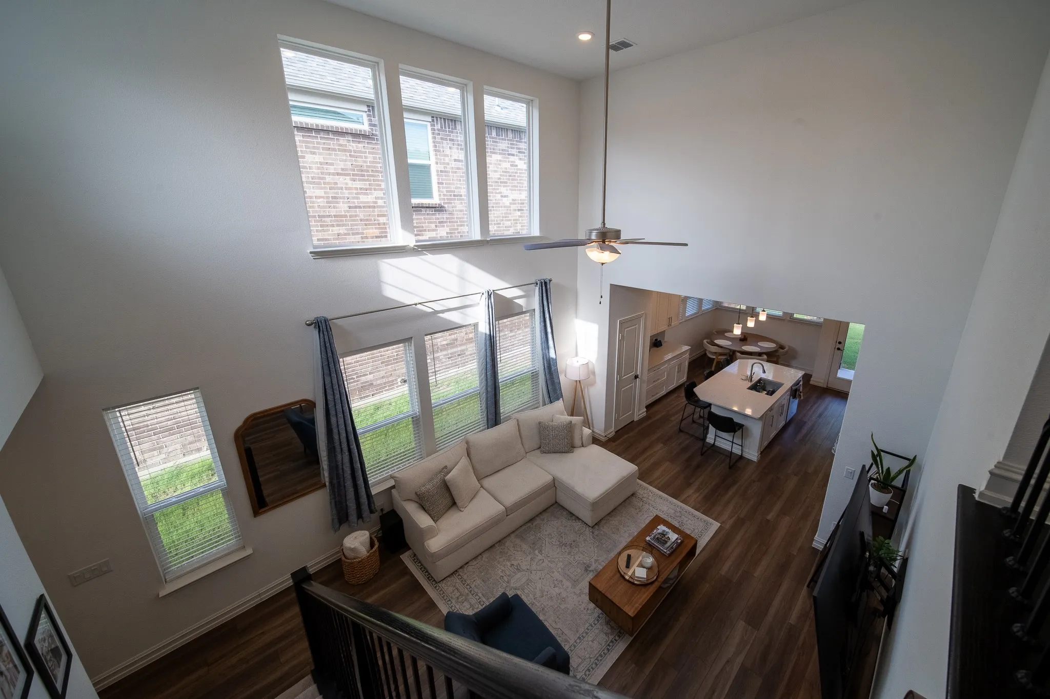 Two-story living area with high ceilings and upper-level windows