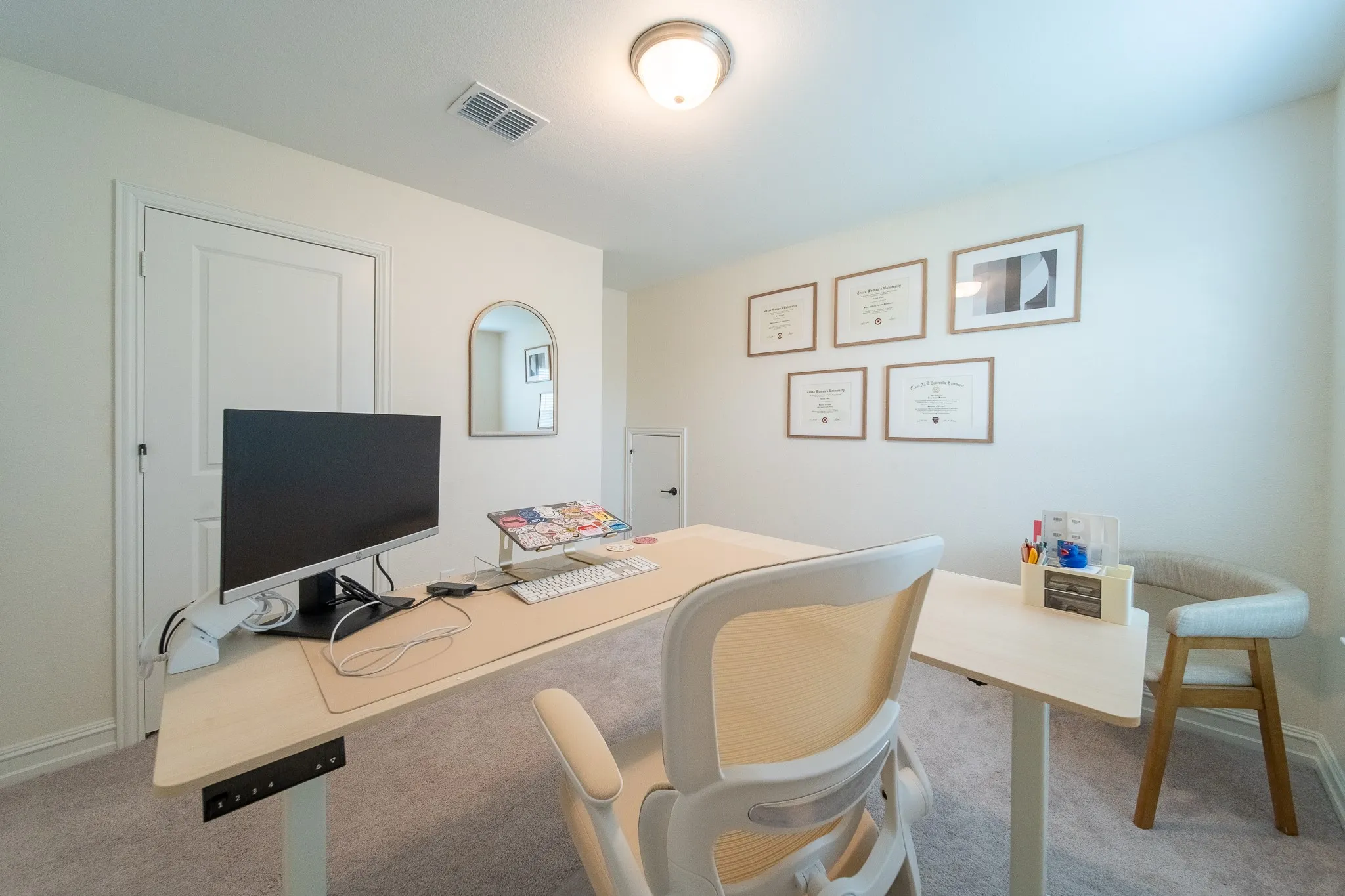 Light-filled room featuring neutral wall paint, white trim, and light gray carpeting