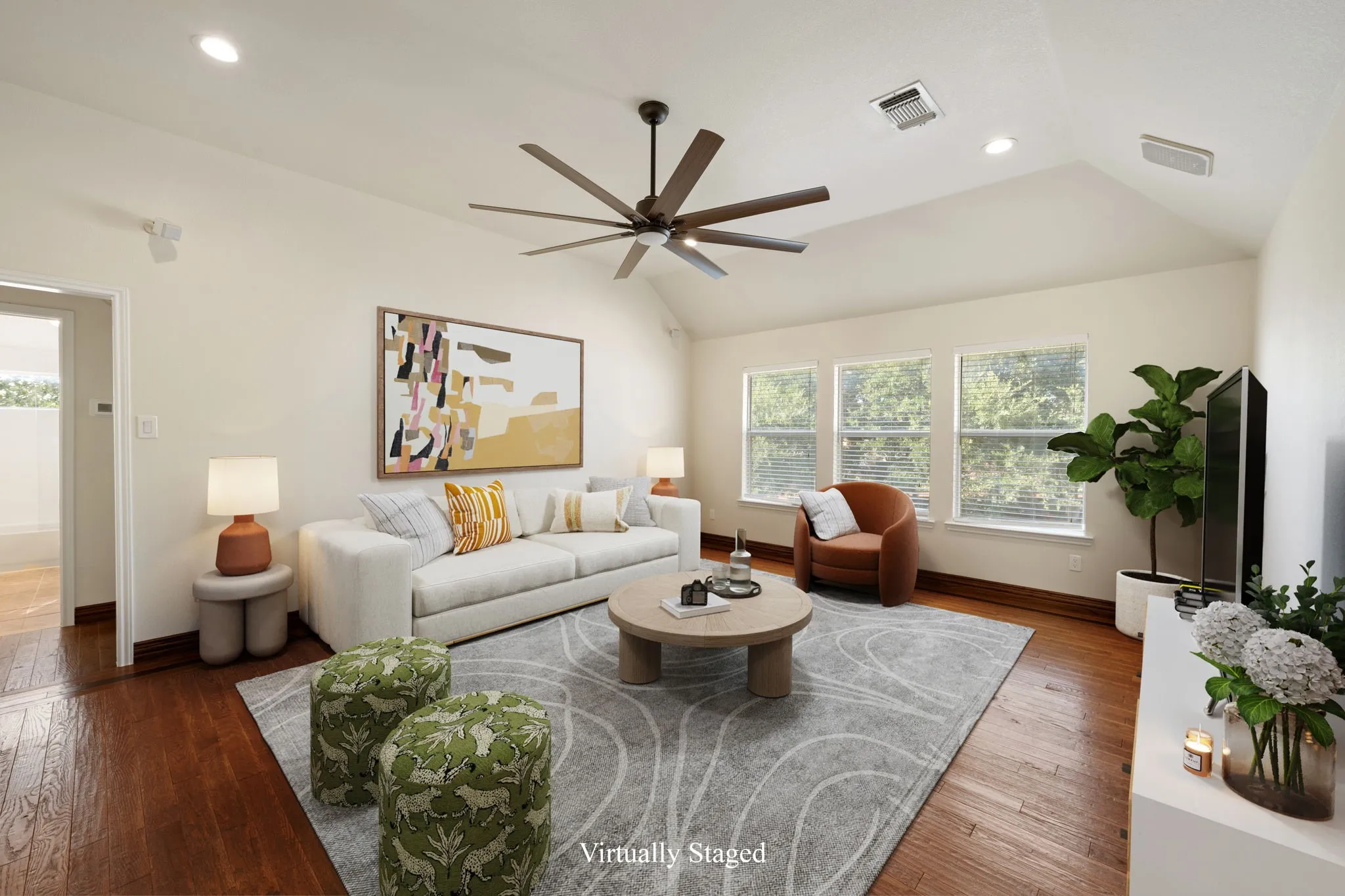 Upstairs living area featuring a vaulted ceiling and dark wood-finish flooring