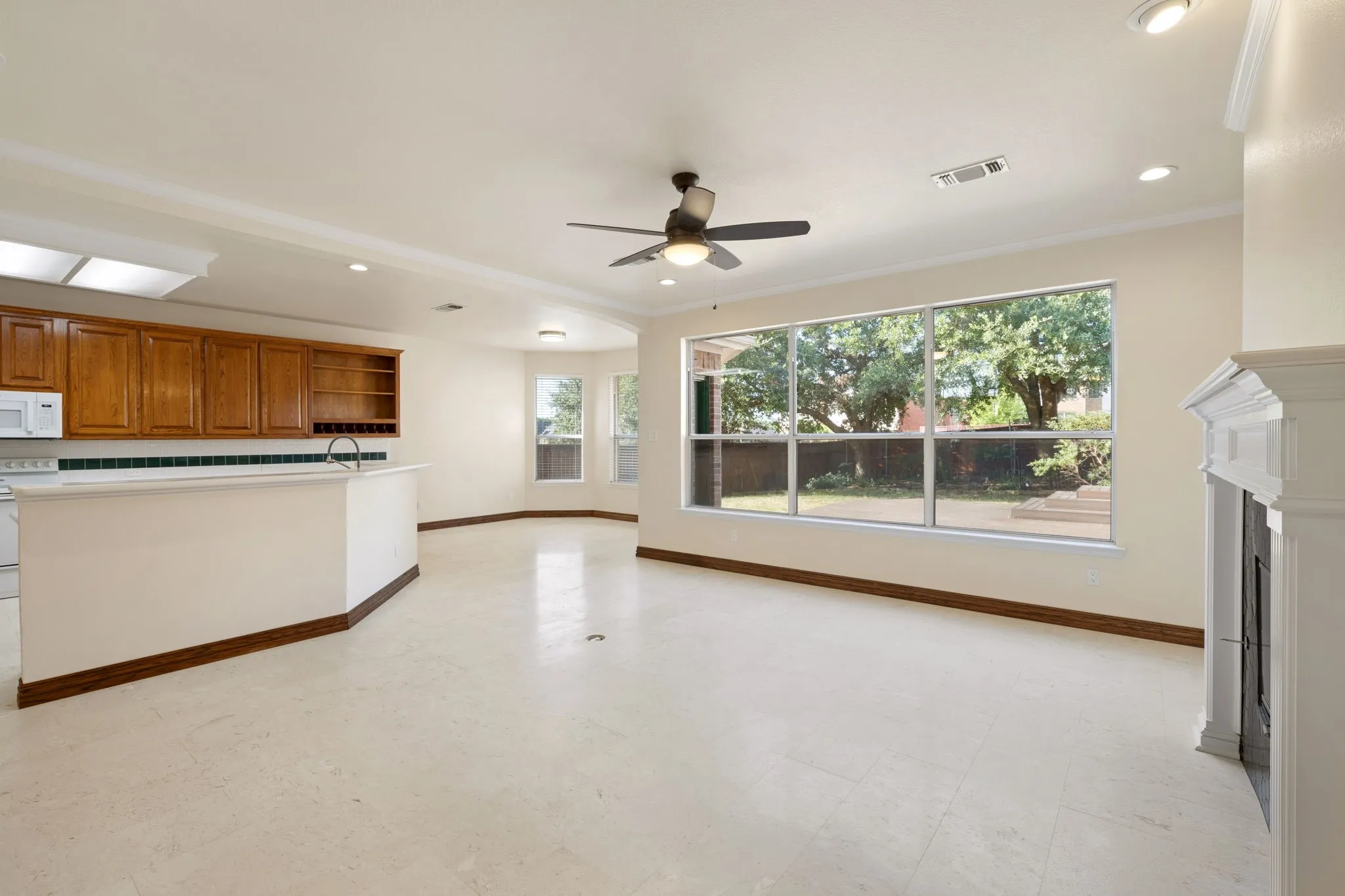View of downstairs formal living room, kitchen, and dining.