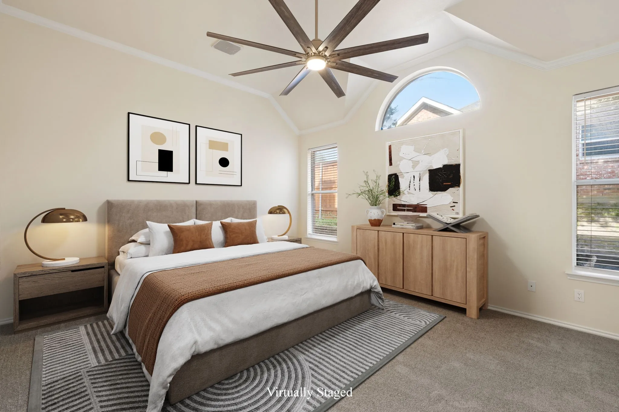 Primary bedroom with vaulted ceiling with crown molding and a large ceiling fan
