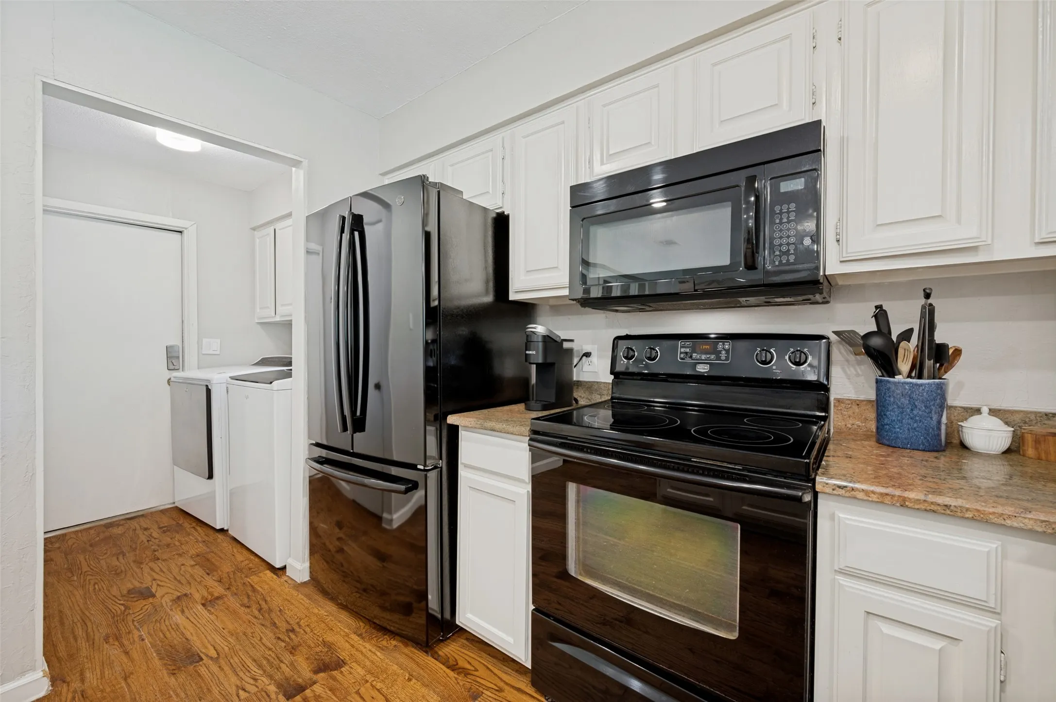 Utility Room accommodates full sized washer/dryer and  is conveniently located between the Kitchen and door to Garage