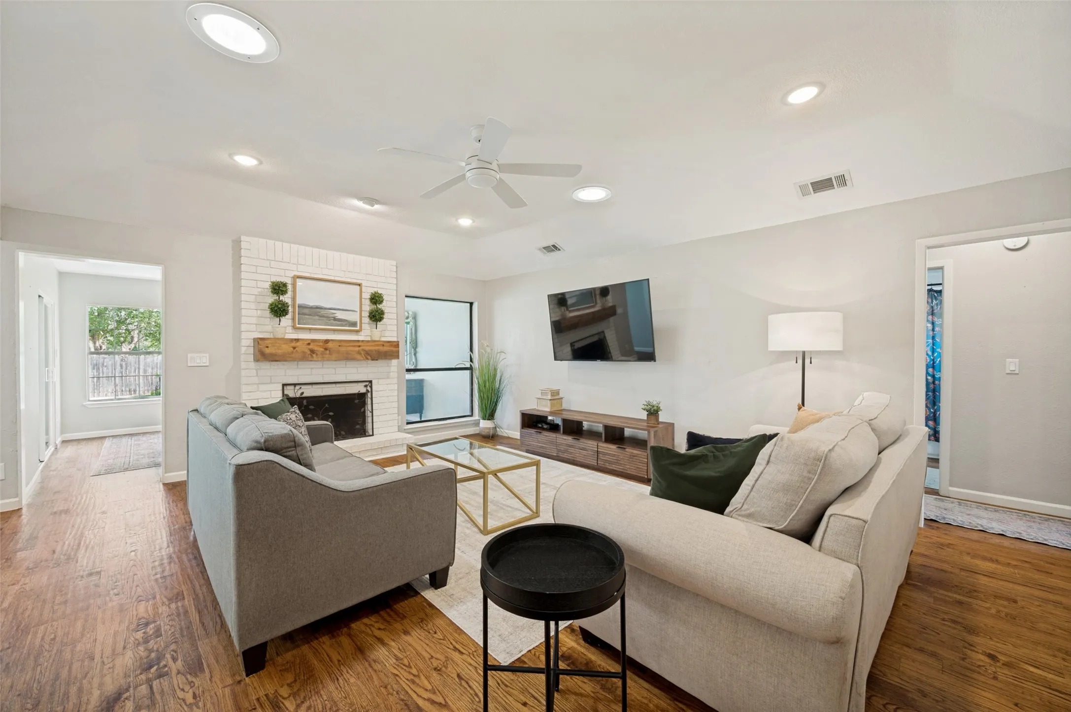  Living area includes a white-painted brick fireplace with a wood mantel