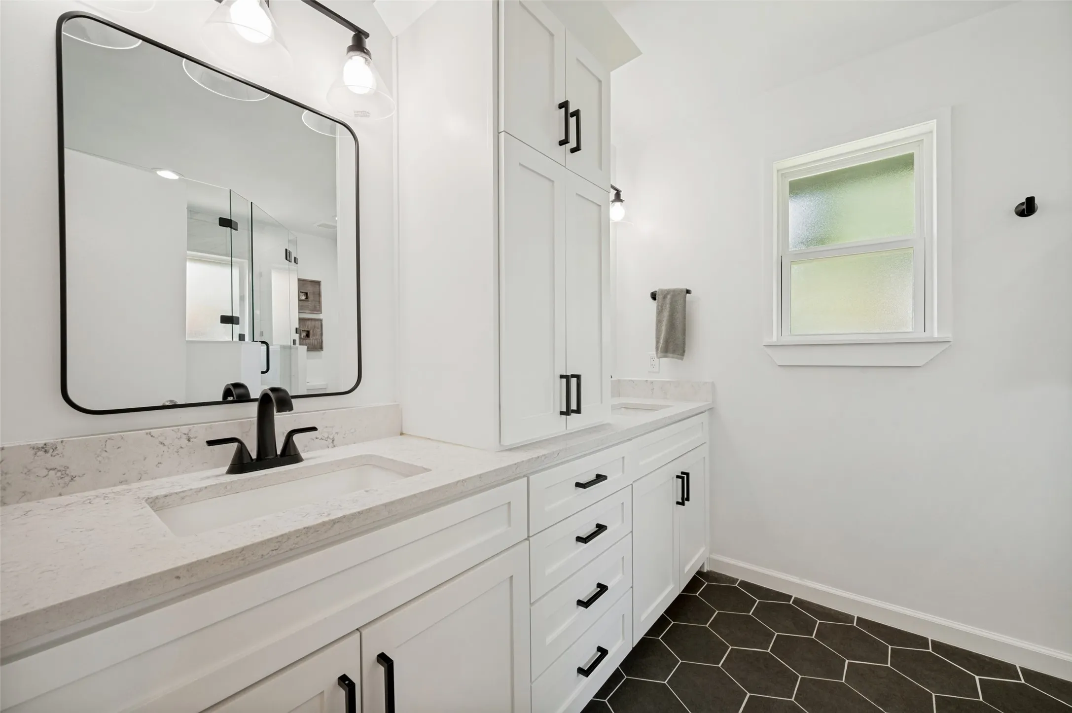 Dual vanity with light-toned countertops and integrated sinks