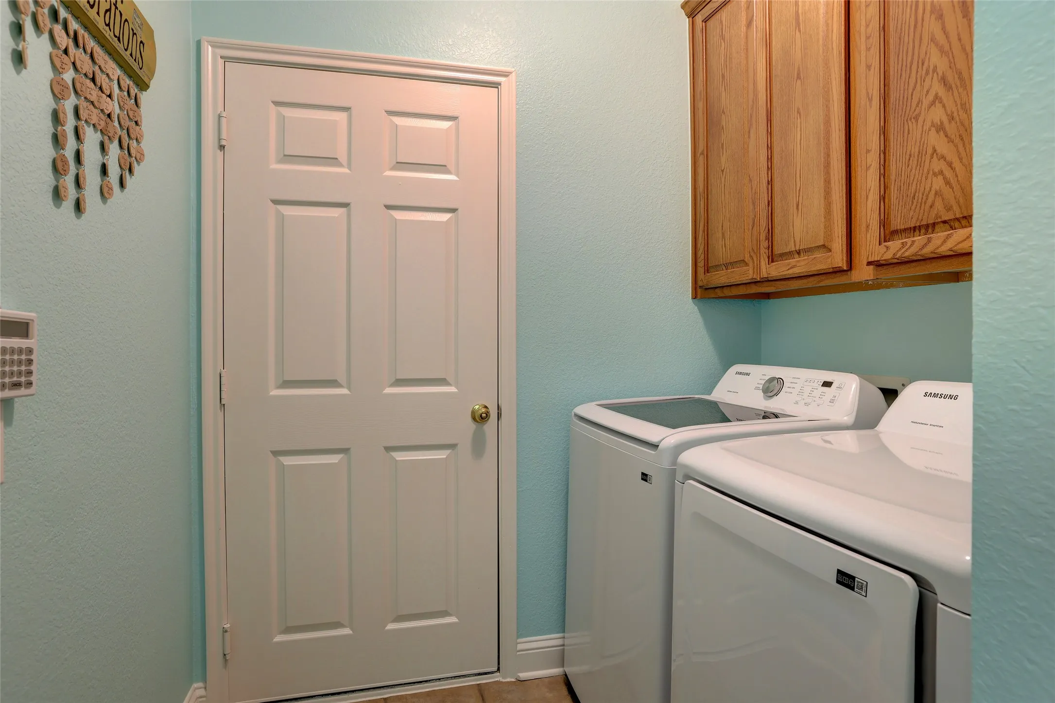 Separate laundry room with utility closet leading to garage