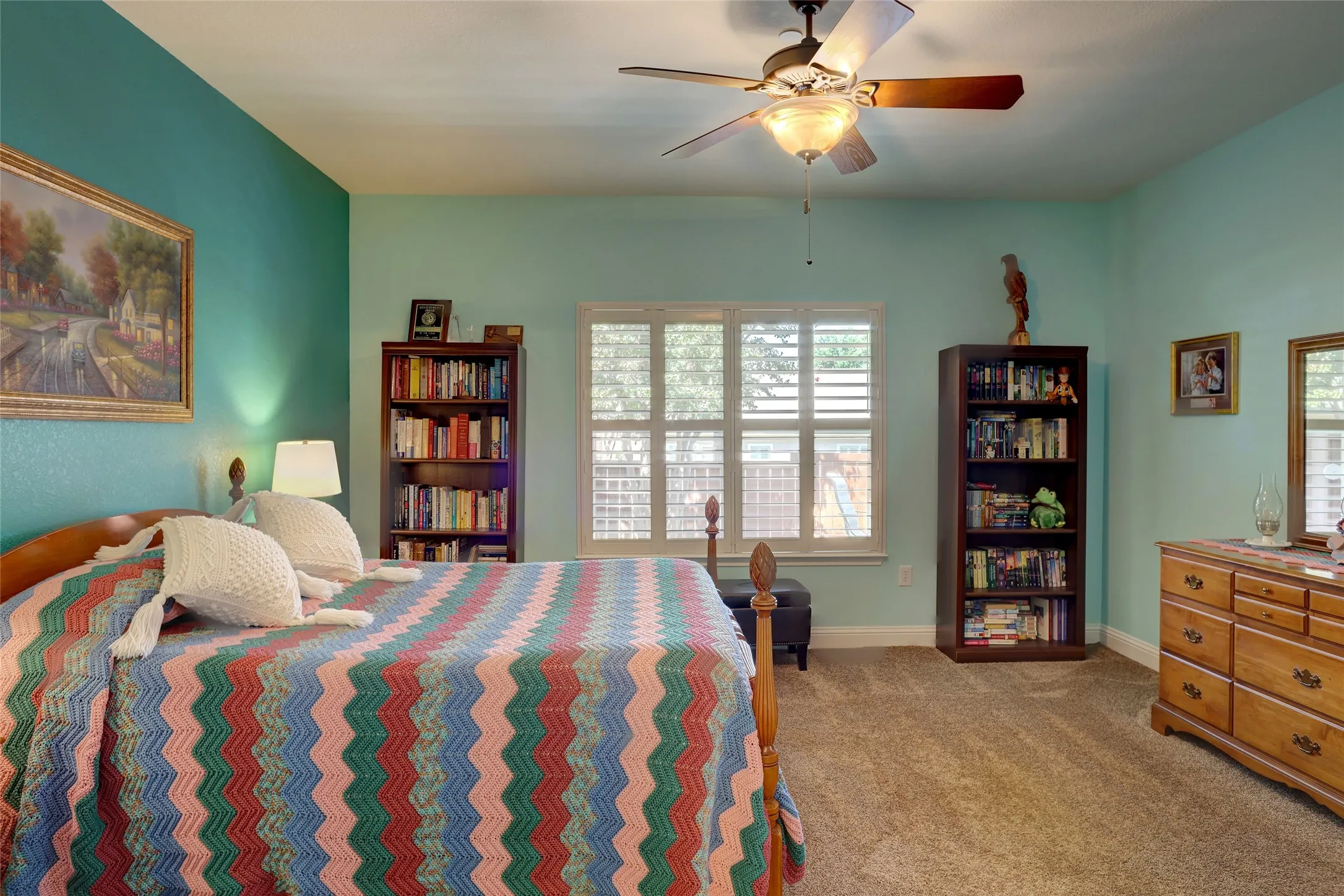 Master with huge window-plantation shutters throughout home