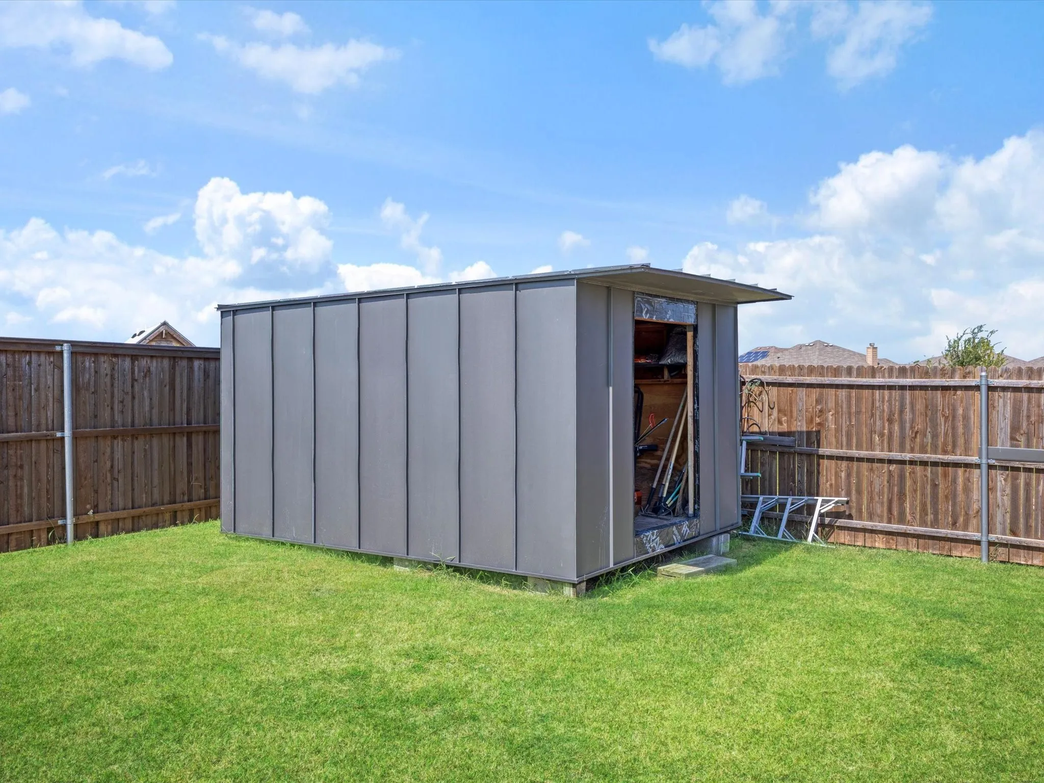 Freestanding storage shed with sloped roof and metal siding