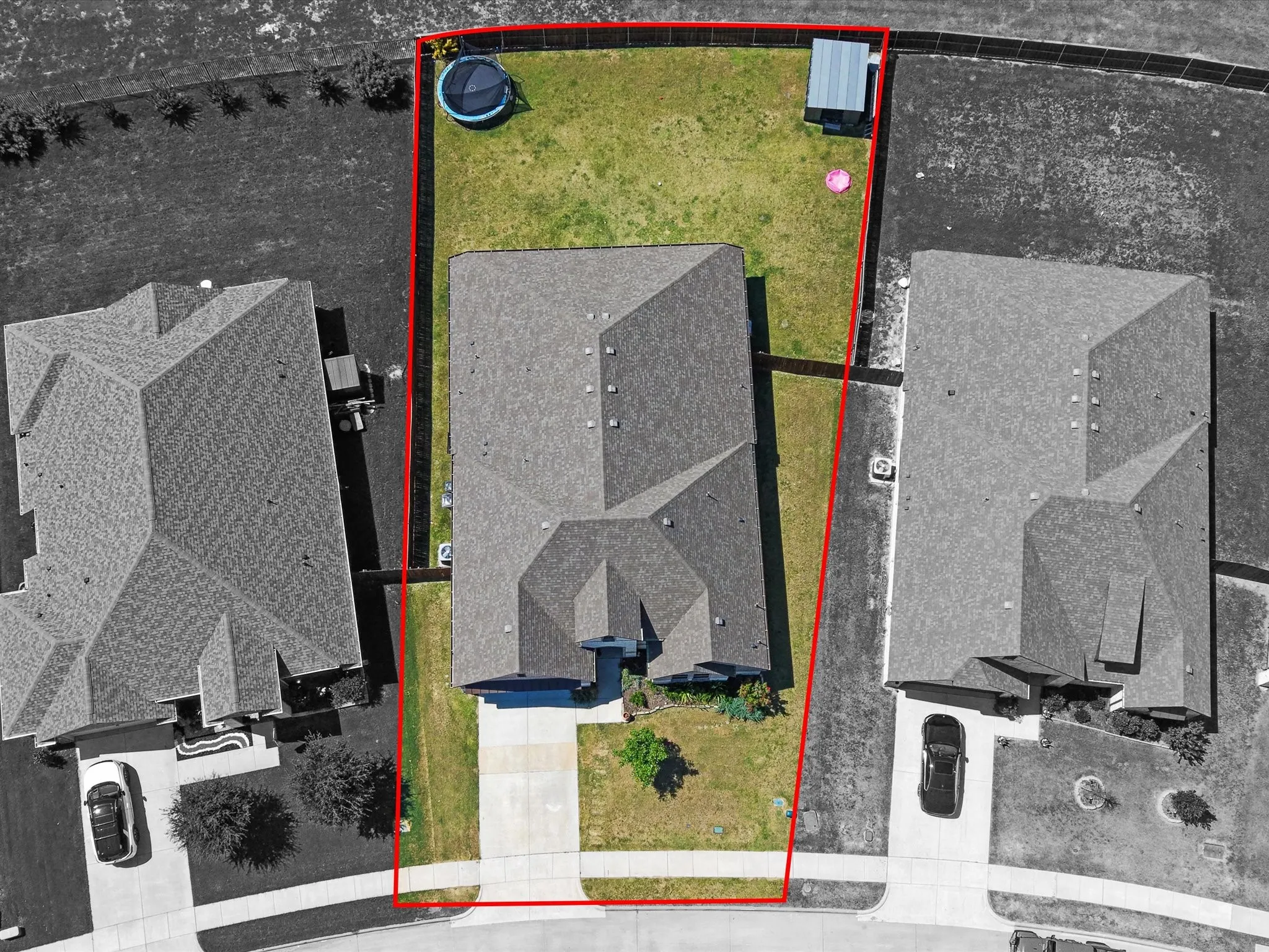 Aerial perspective showcasing a pitched roofline and a rectangular lot