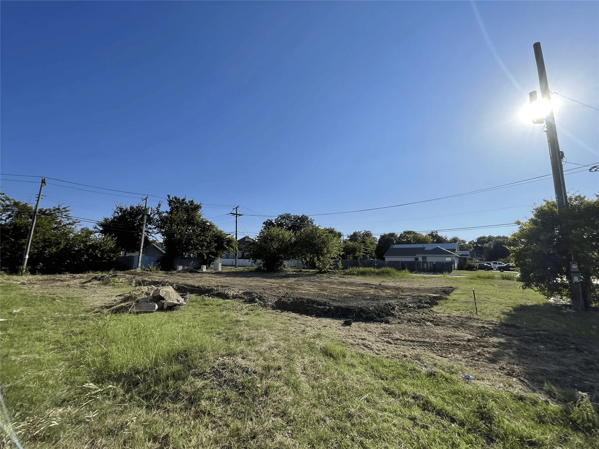 Cleared lot featuring exposed soil and surrounding grass