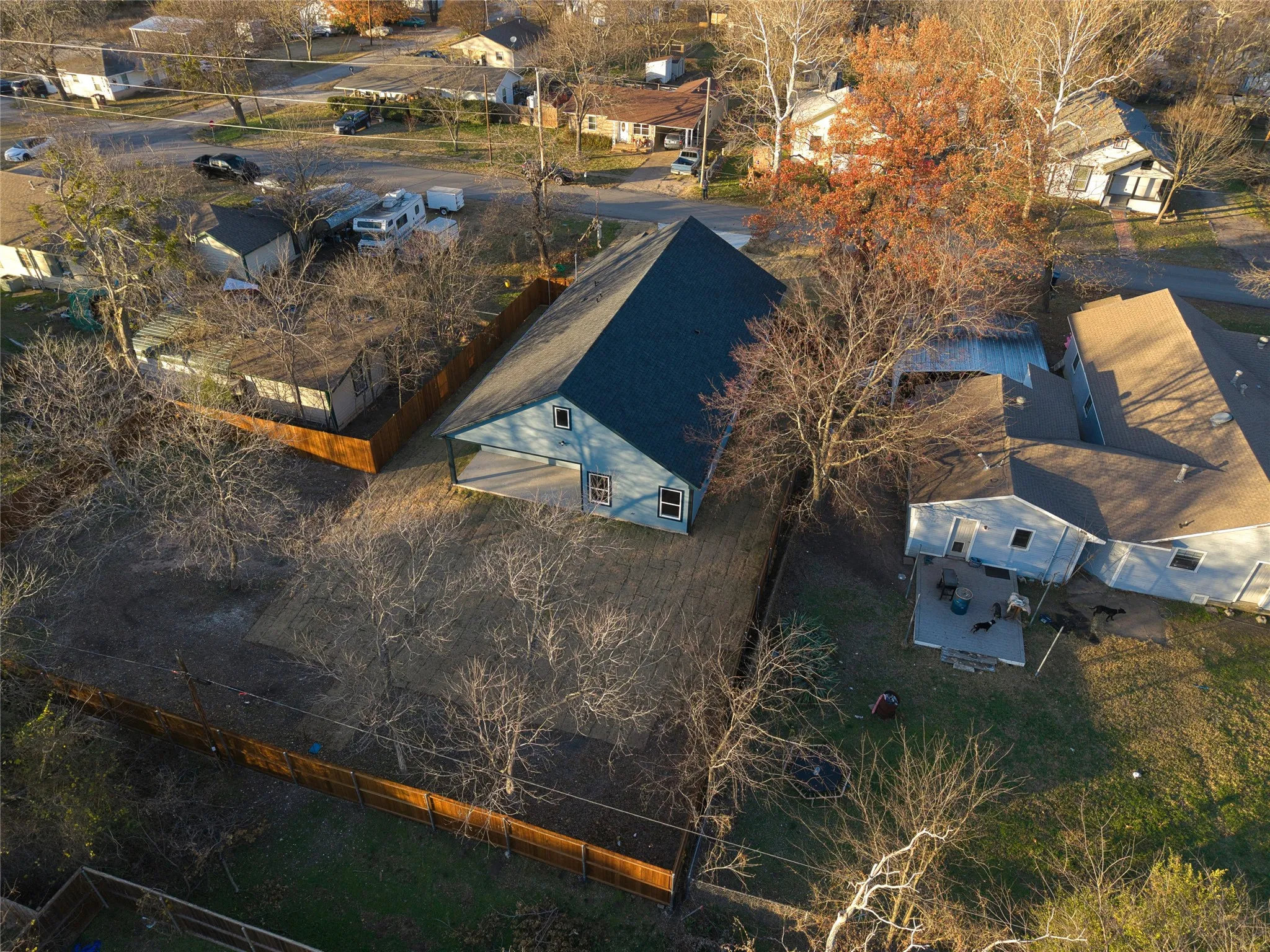 Aerial perspective of a property featuring a light blue exterior with white trim and a dark-colored roof
