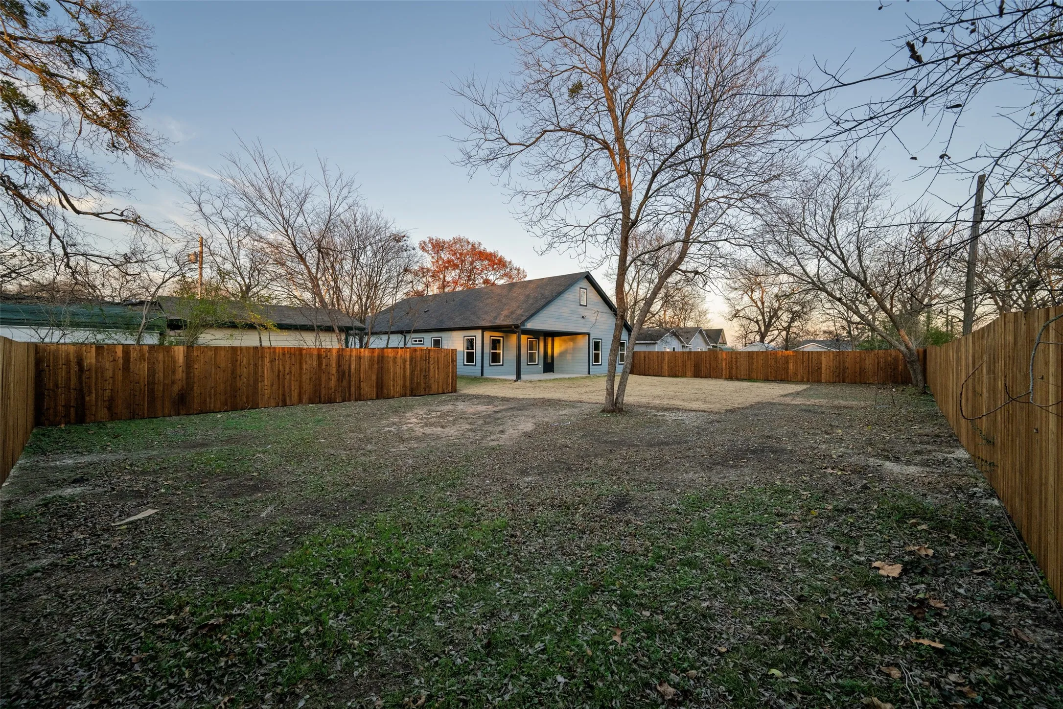 Spacious, level backyard with a full perimeter wood privacy fence