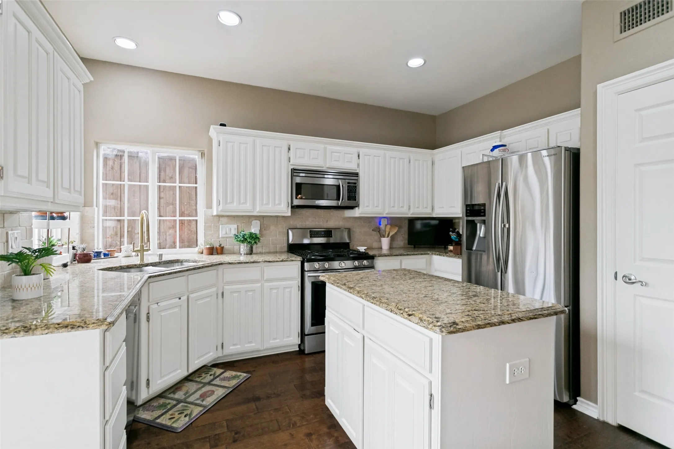 Spacious kitchen with breakfast bar and open layout.