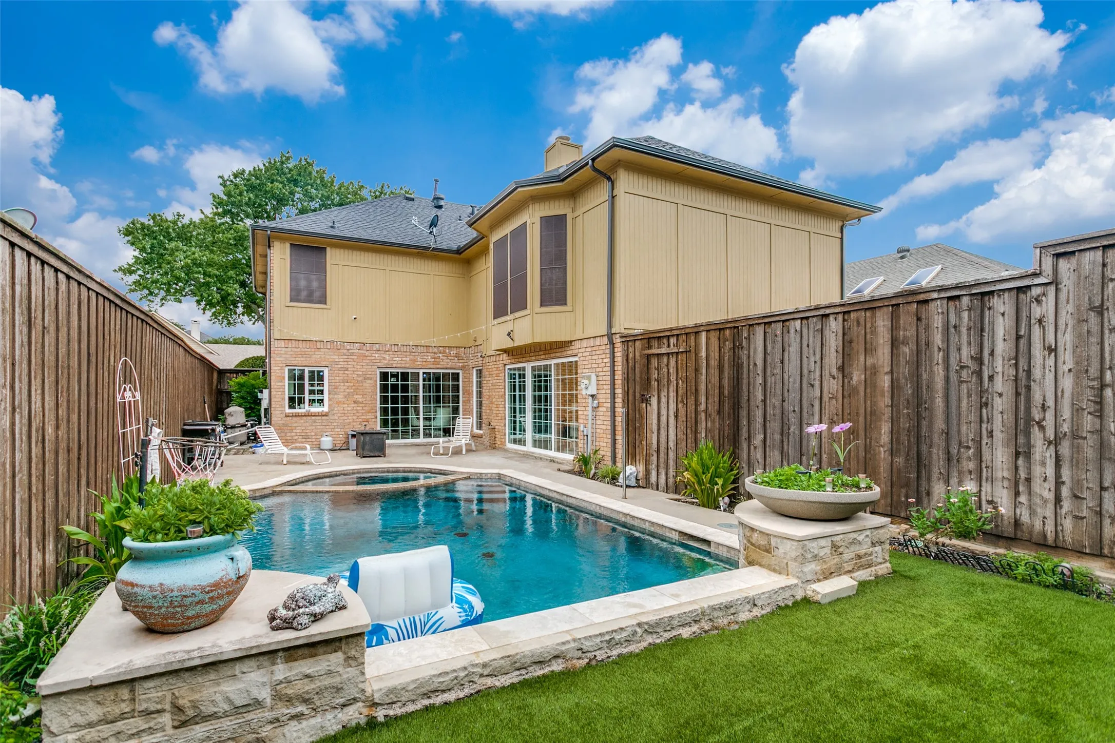 Backyard view showcasing the pool and outdoor entertaining area.