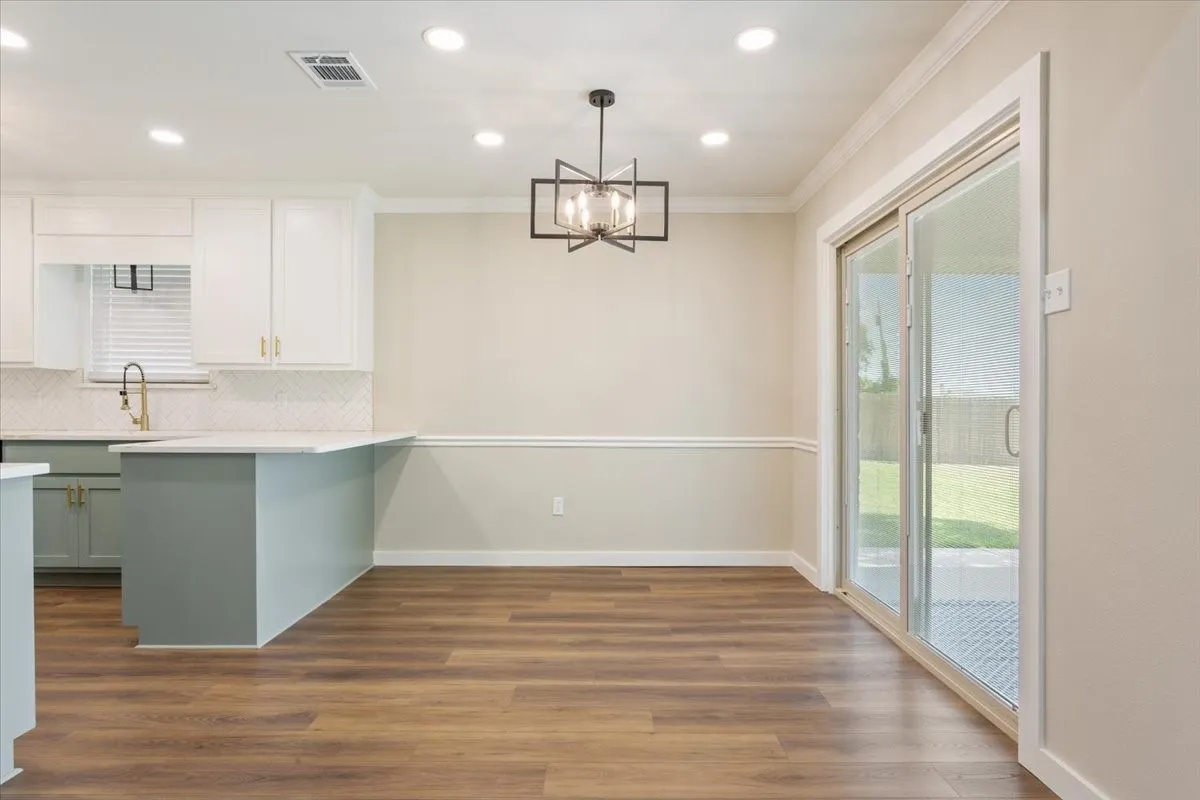 Dining area with an eat-in kitchen peninsula bar and featuring sliding glass door access to the covered back porch