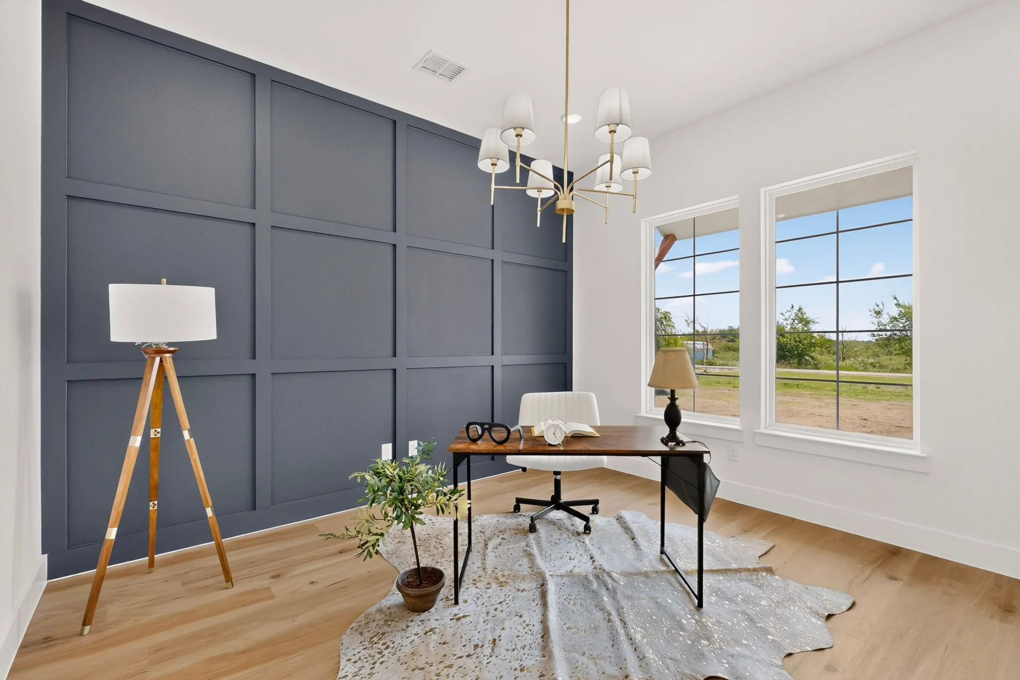 Accent wall featuring dark blue wainscoting and light wood-finish flooring