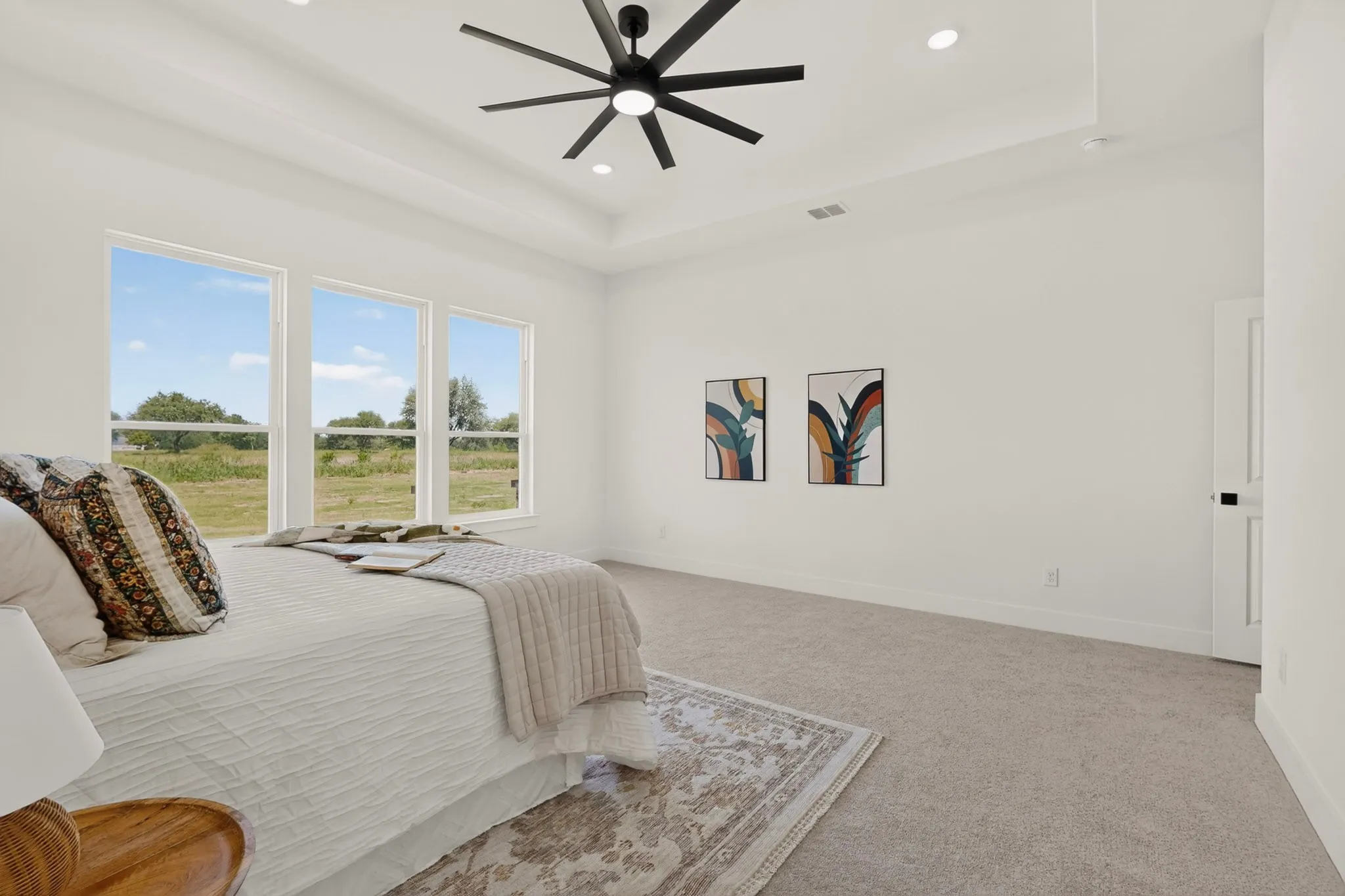 Room featuring a tray ceiling with a contemporary ceiling fan and recessed lighting