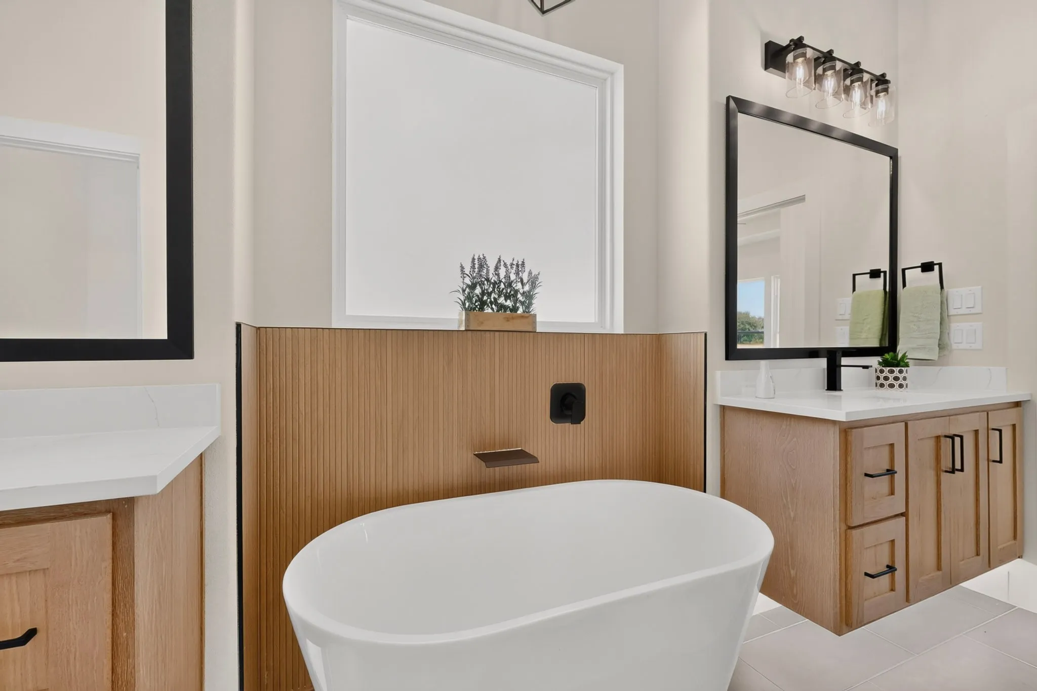 Freestanding soaking tub with a wall-mounted faucet, ribbed wood-finish paneling, and a large window