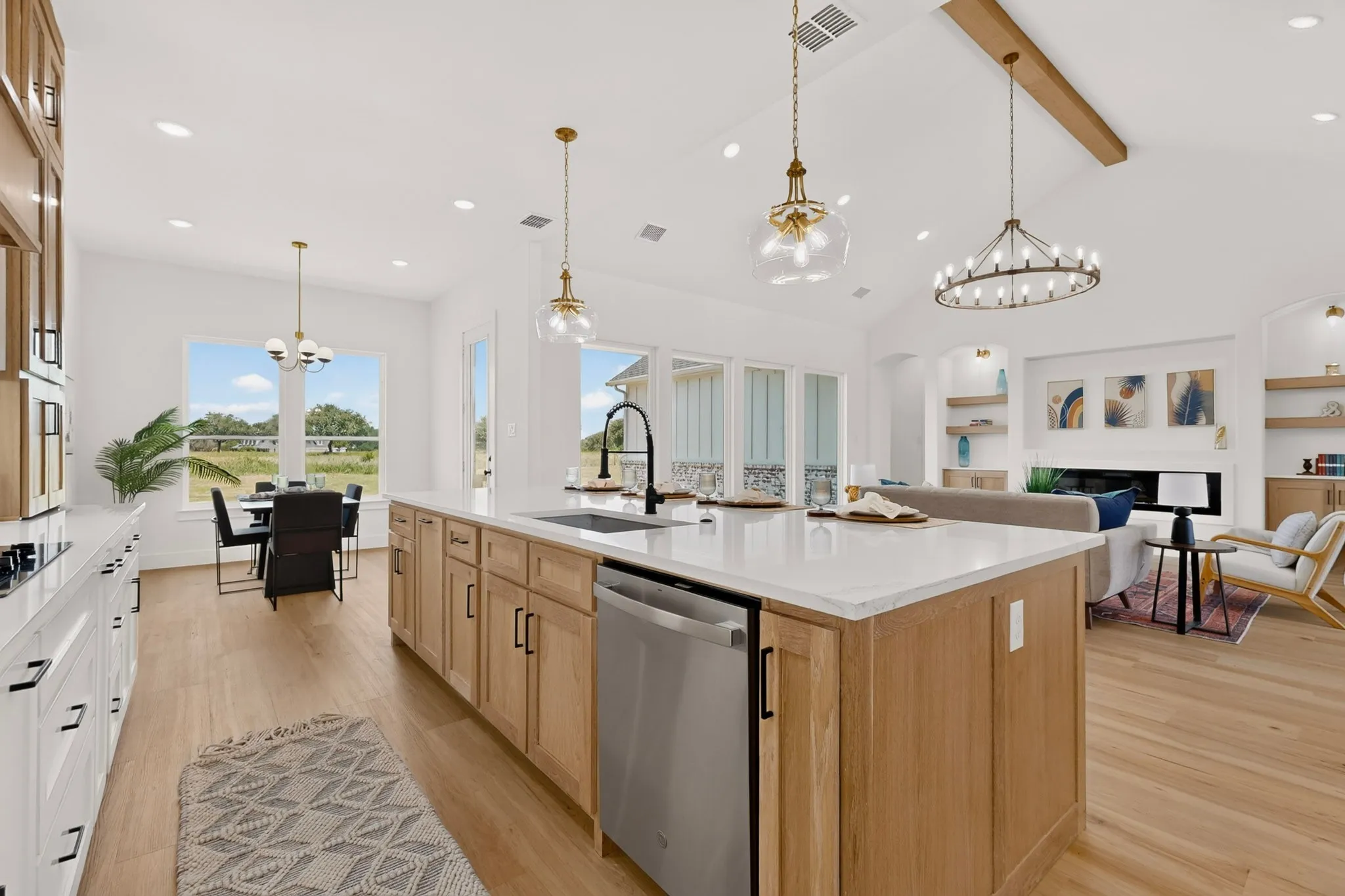Spacious kitchen island featuring a white countertop, built-in dishwasher, and ample cabinet storage